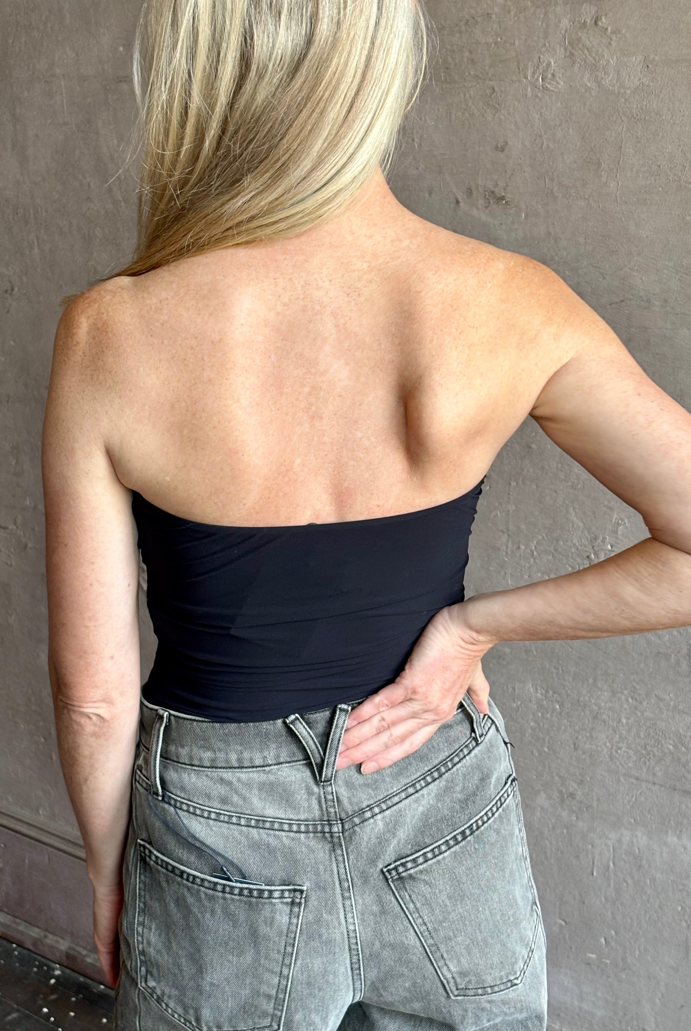 Image of mature woman wearing AGOLDE Gwyneth Bodysuit in black with premium stretch for timeless versatile styling