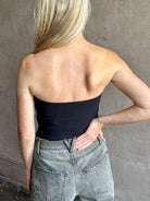 Image of mature woman wearing AGOLDE Gwyneth Bodysuit in black with premium stretch for timeless versatile styling