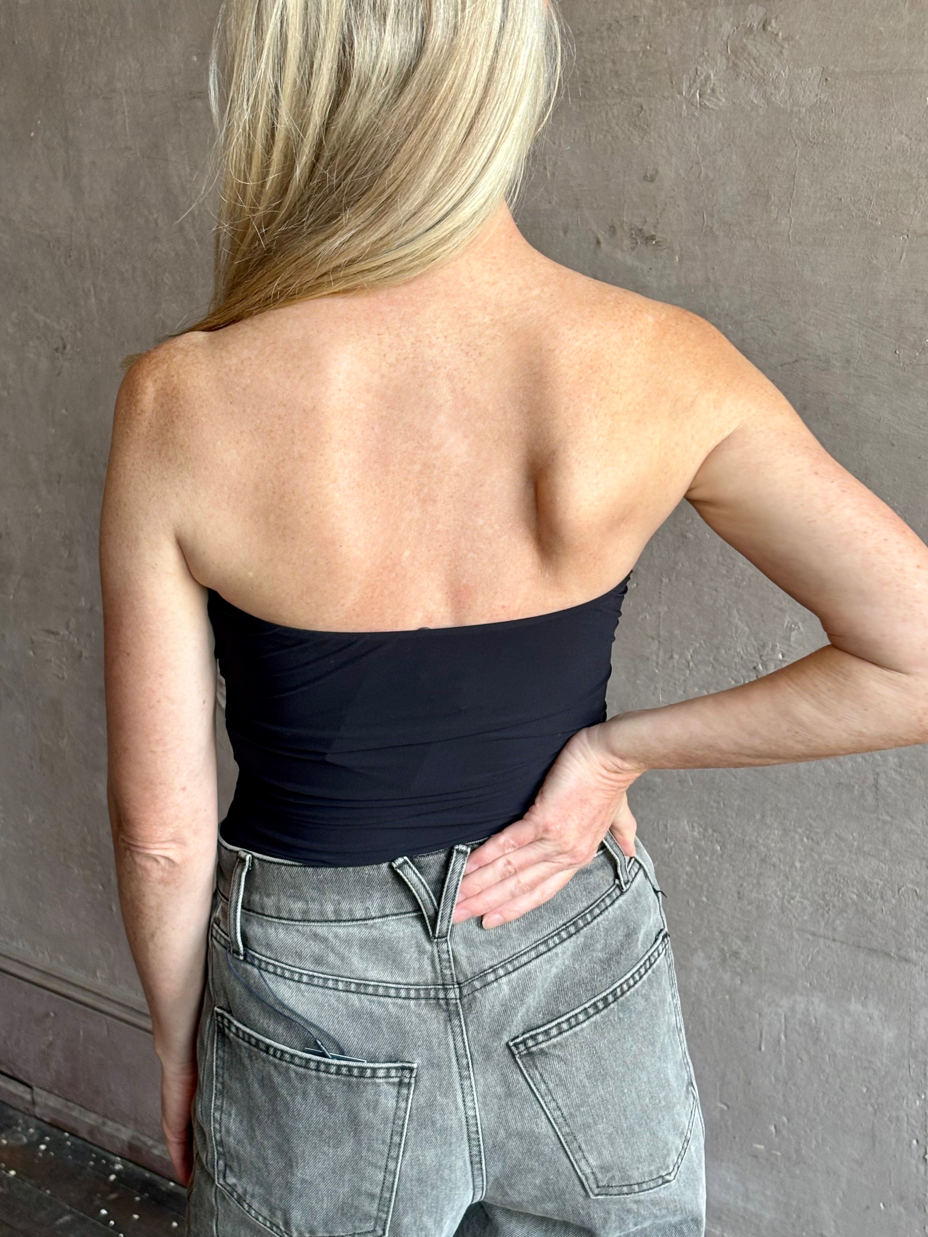 Image of mature woman wearing AGOLDE Gwyneth Bodysuit in black with premium stretch for timeless versatile styling