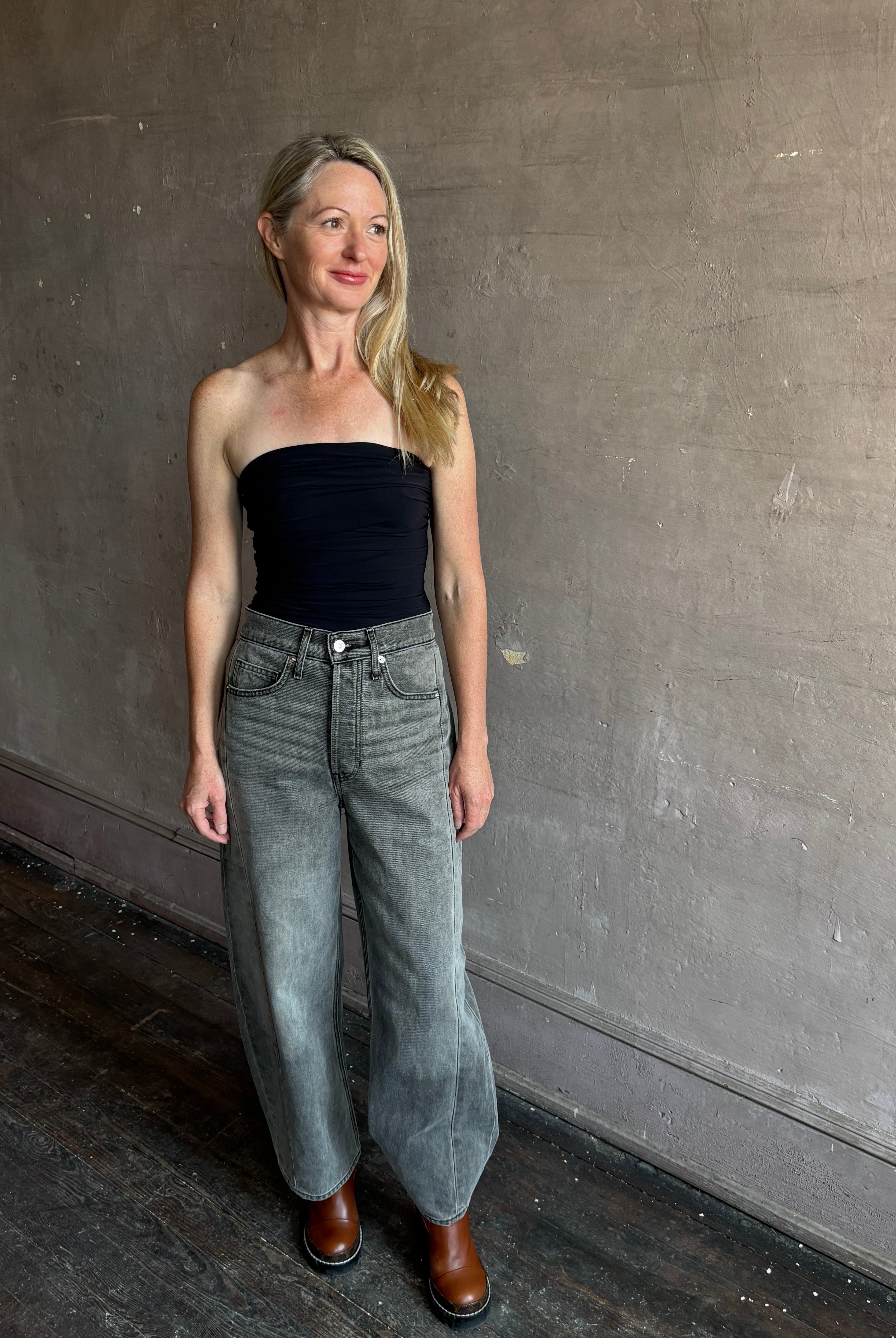 Image of mature woman wearing AGOLDE Gwyneth Bodysuit in black with premium stretch for timeless versatile styling