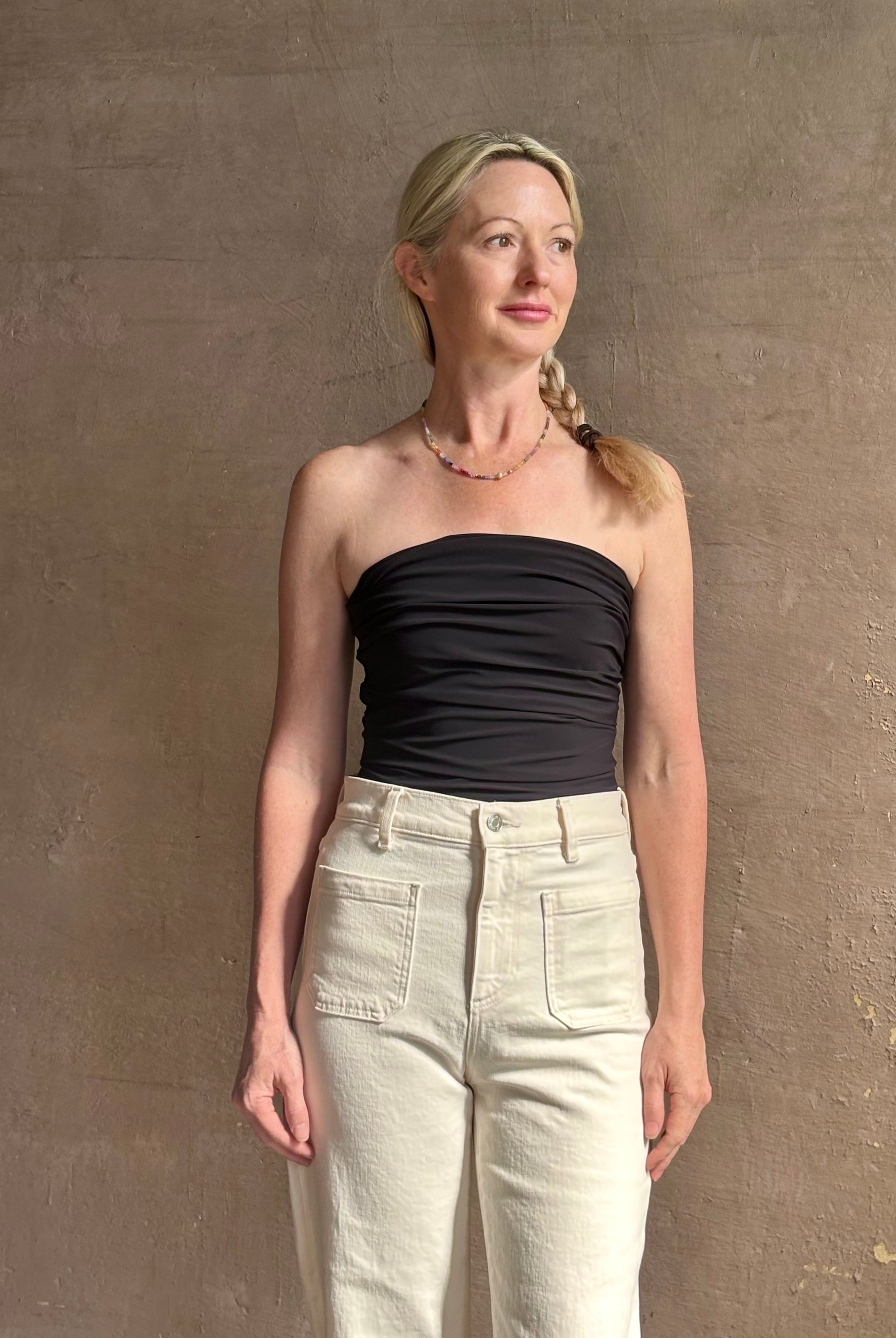 Mature woman wearing AGOLDE Gwyneth Bodysuit in black with premium stretch for timeless versatile styling