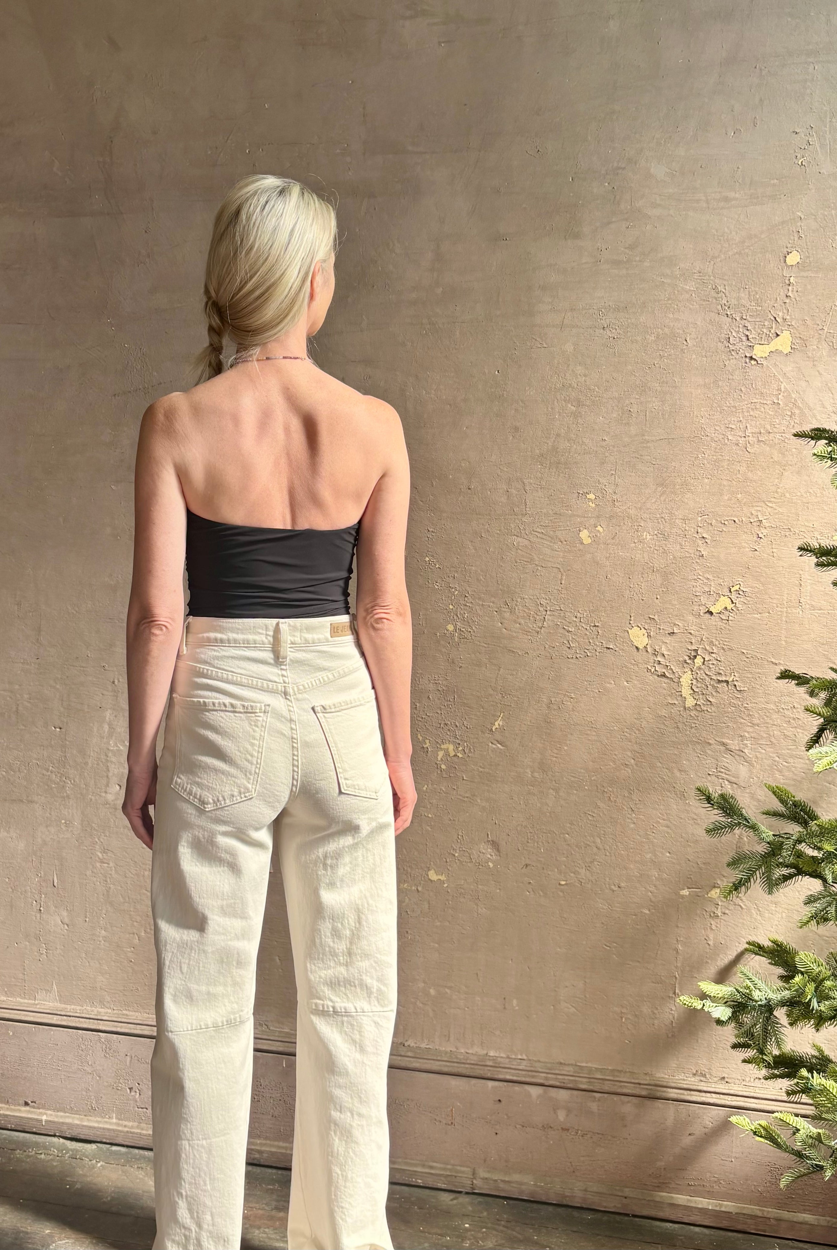 Mature woman wearing AGOLDE Gwyneth Bodysuit in black with premium stretch for timeless versatile styling