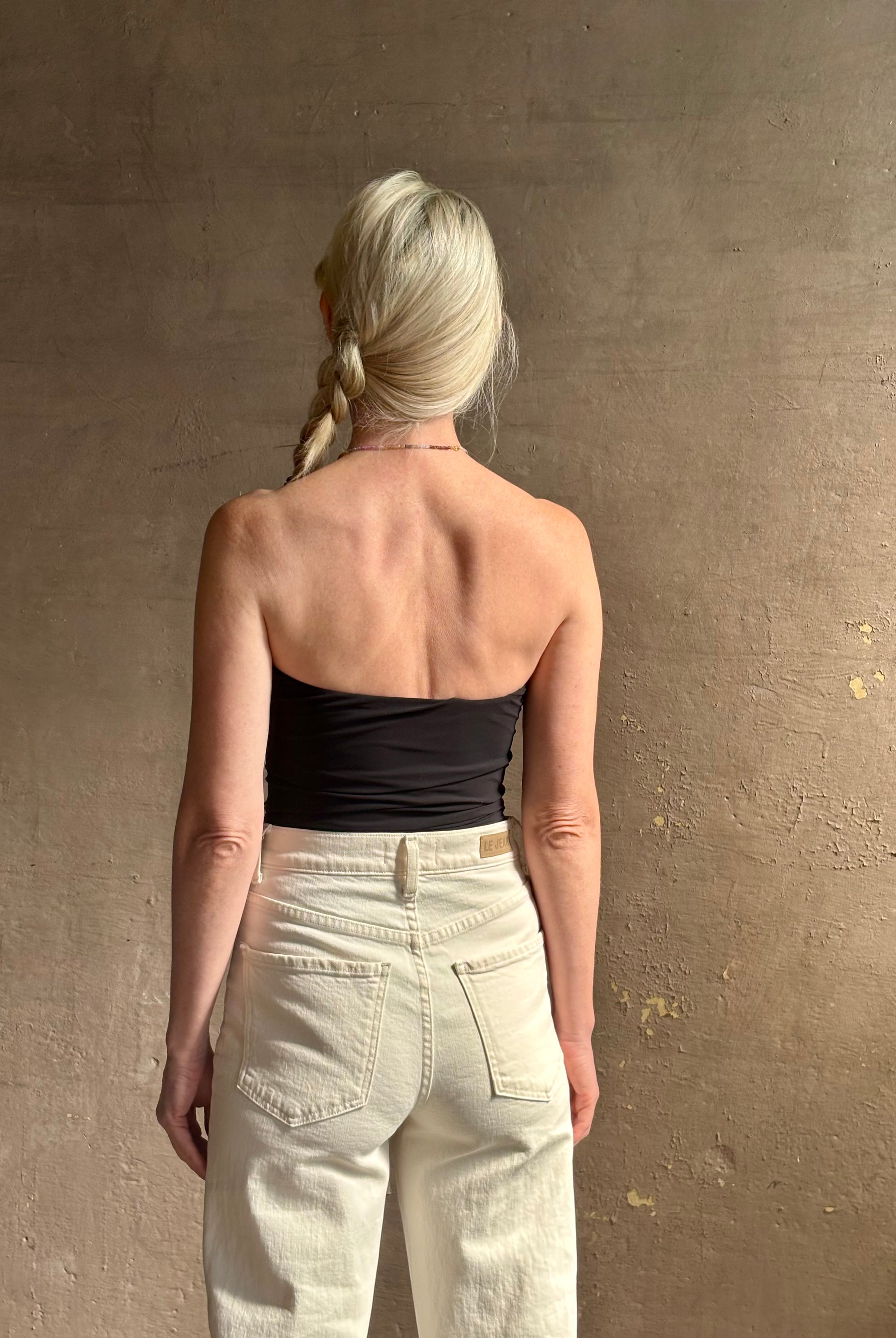 Mature woman wearing AGOLDE Gwyneth Bodysuit in black with premium stretch for timeless versatile styling