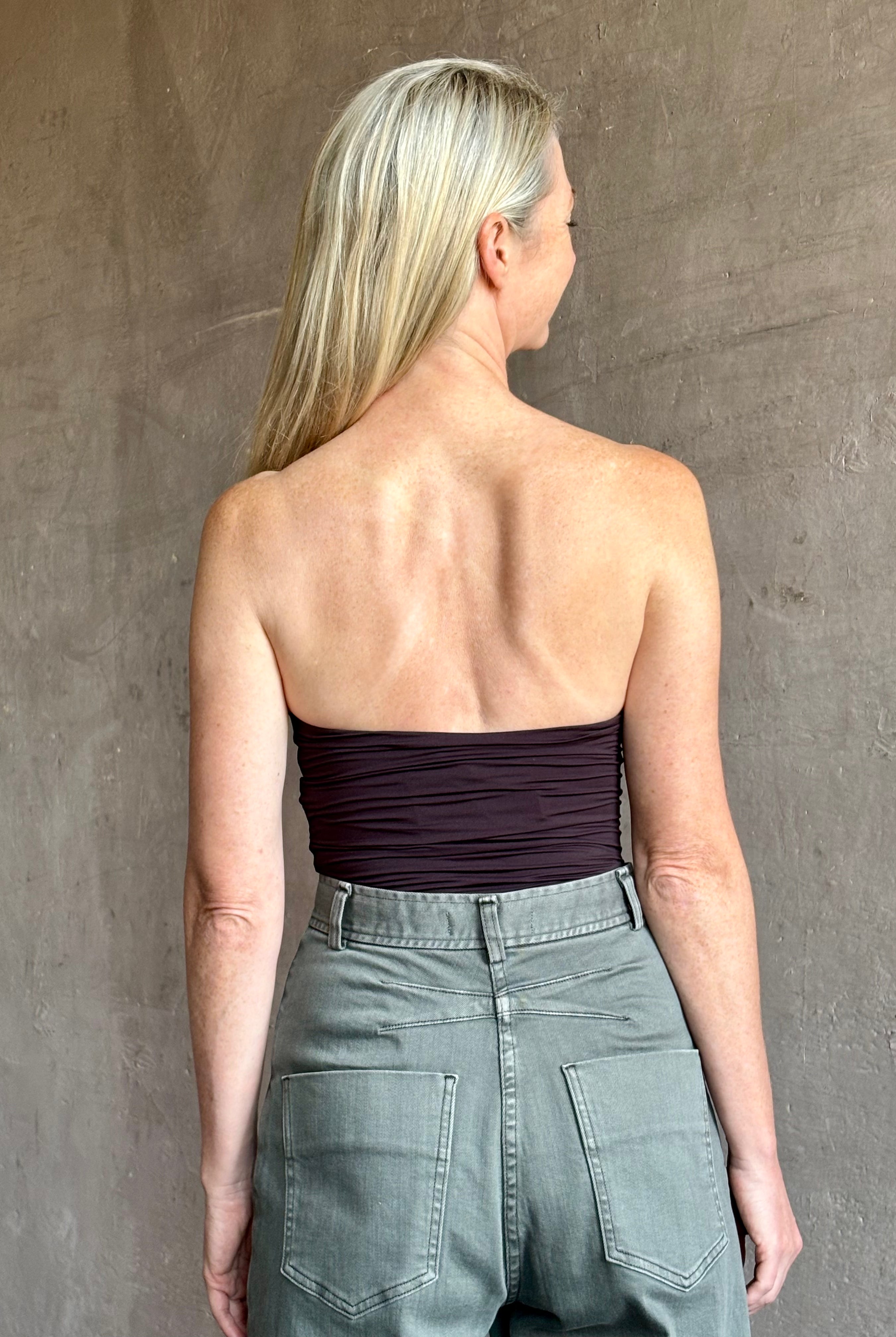 Image of mature woman wearing AGOLDE Gwyneth Bodysuit in chocolate brown with premium stretch for timeless versatile styling