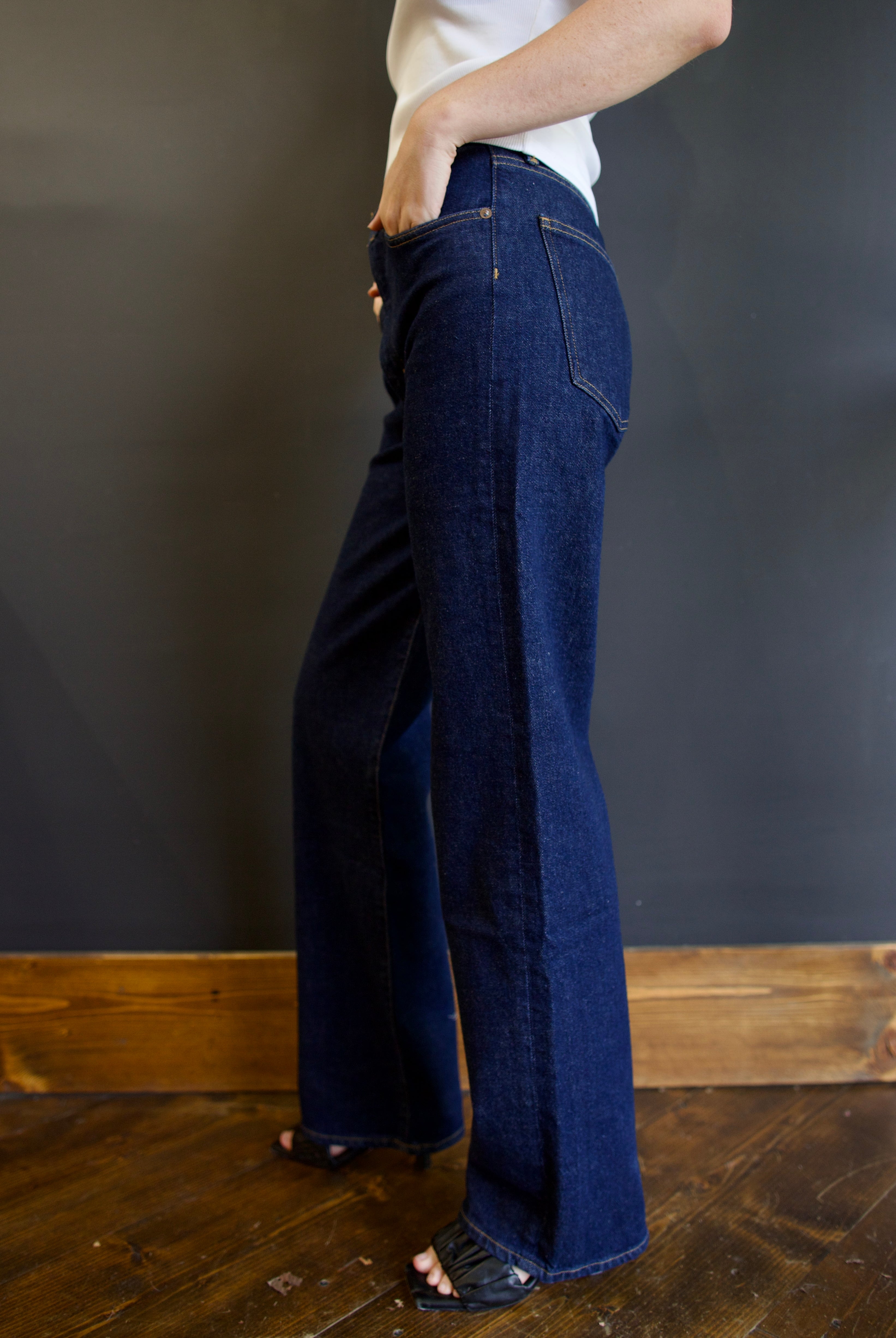 Model wearing Agolde harper denim in reissue wash that is not distressed, full length with a finished hem that can easily be dressed up or down