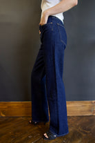 Model wearing Agolde harper denim in reissue wash that is not distressed, full length with a finished hem that can easily be dressed up or down