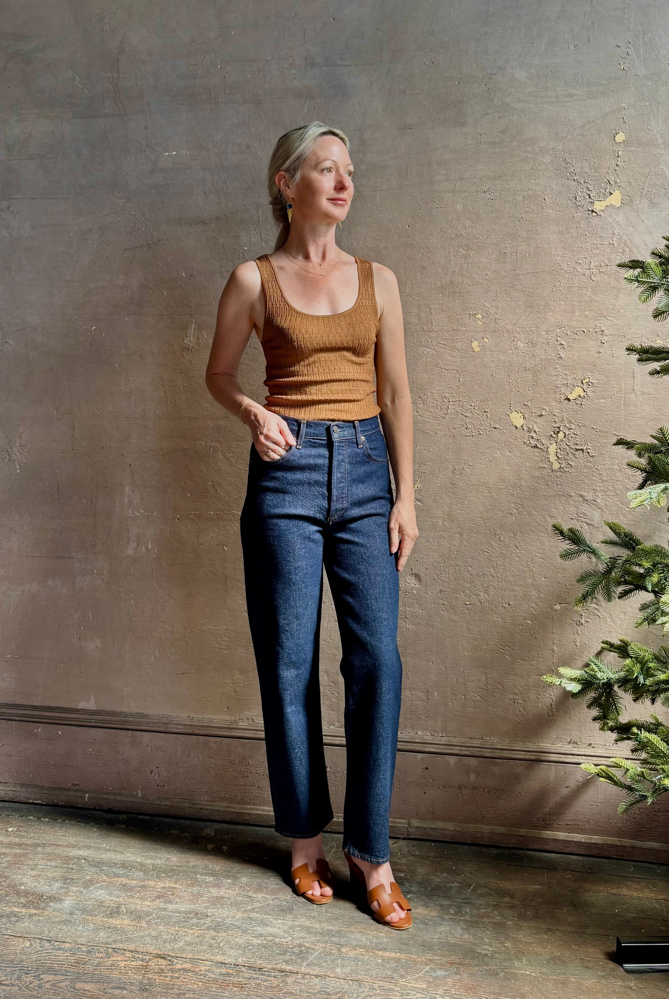 Mature woman wearing Agolde 90's Pinch Waist Crop with regenerative cotton zip closure slim sihlouette