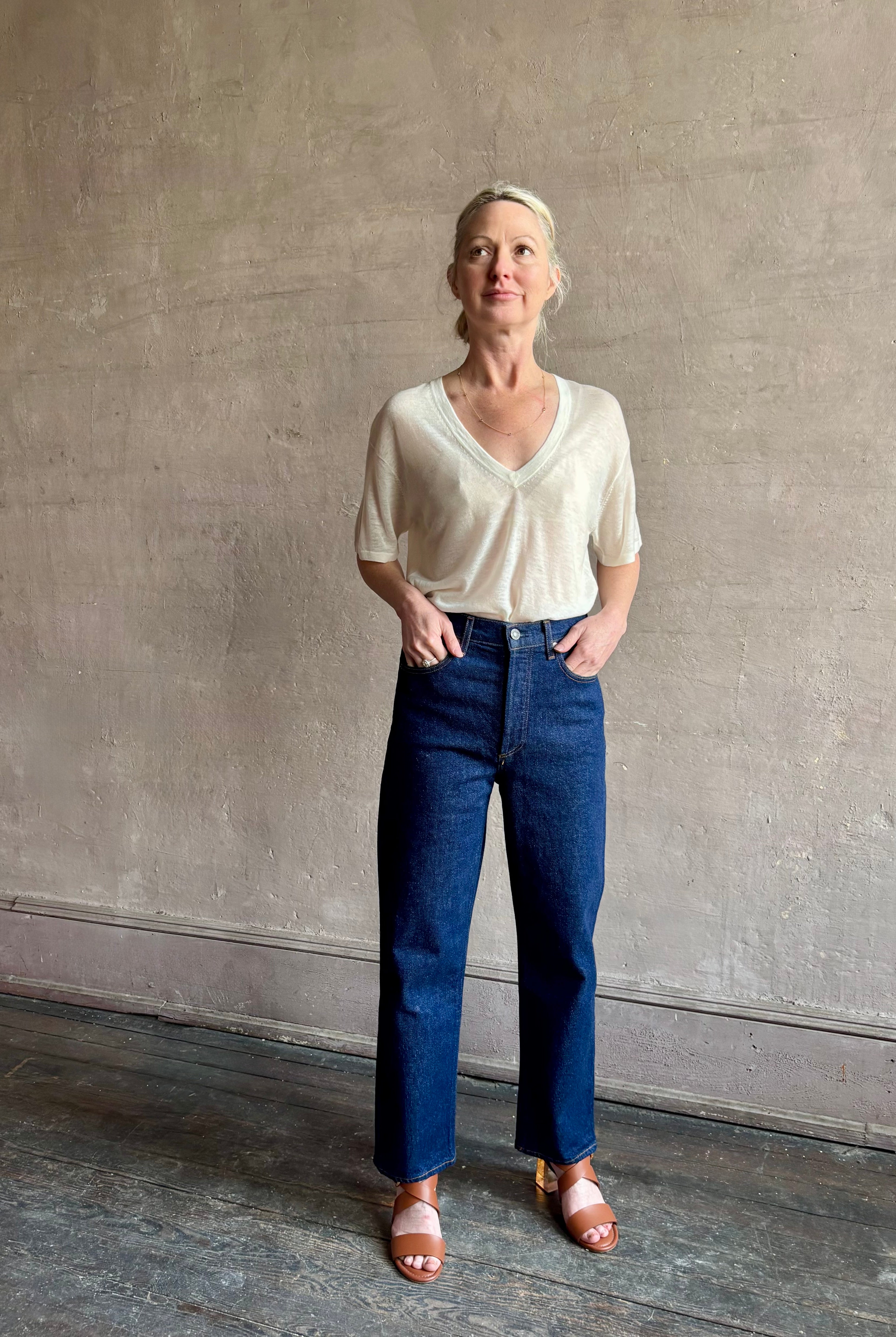 Image of woman wearing premium AGOLDE 90's Pinch Waist Crop in Reissue dark wash with high rise finished hem and slight taper straight leg