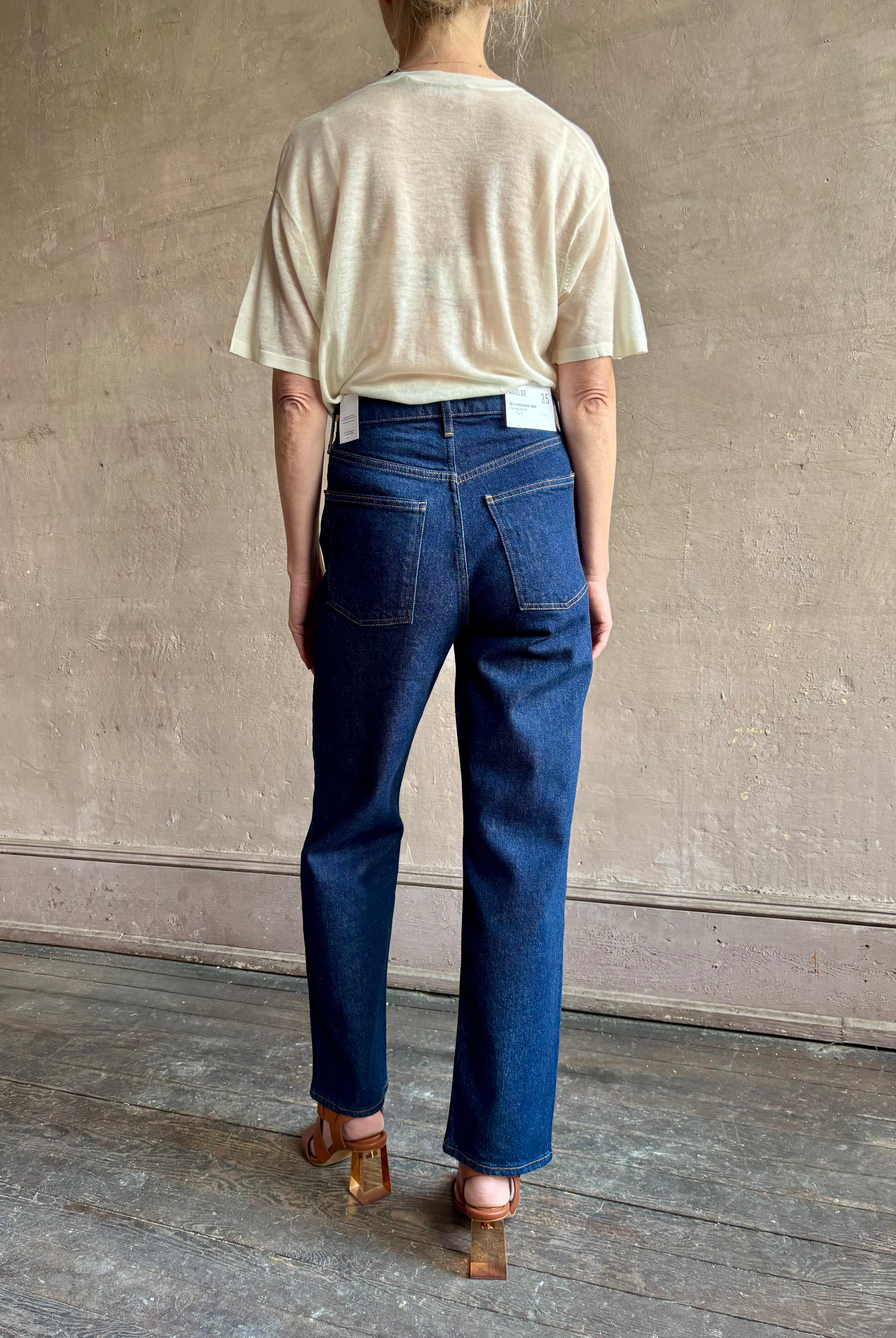 Image of woman wearing premium AGOLDE 90's Pinch Waist Crop in Reissue dark wash with high rise finished hem and slight taper straight leg