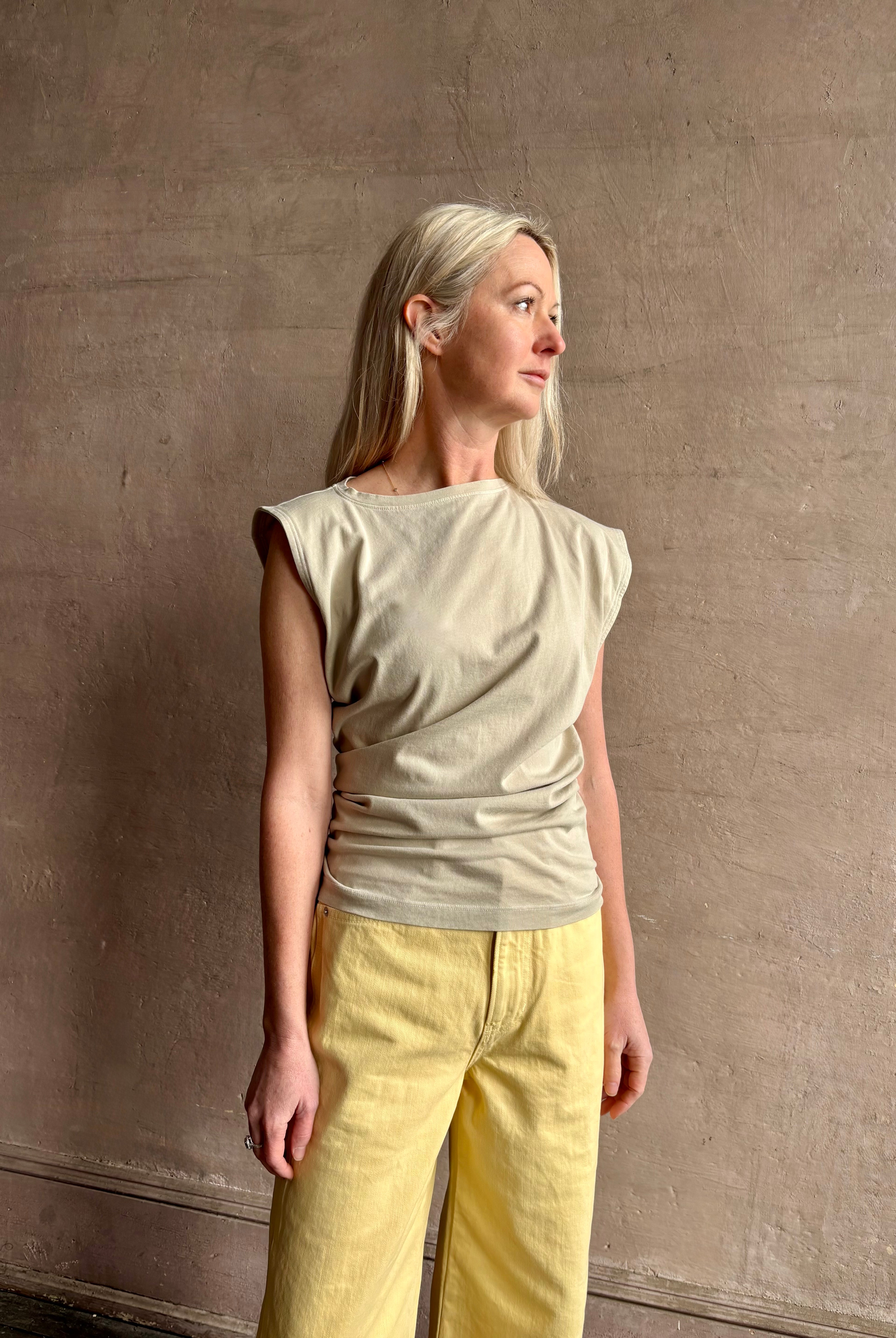 Image of woman wearing - Premium Organic Cotton Luxury Basics AGOLDE Beth Tee in Rice Grass beige with cap sleeves and draping