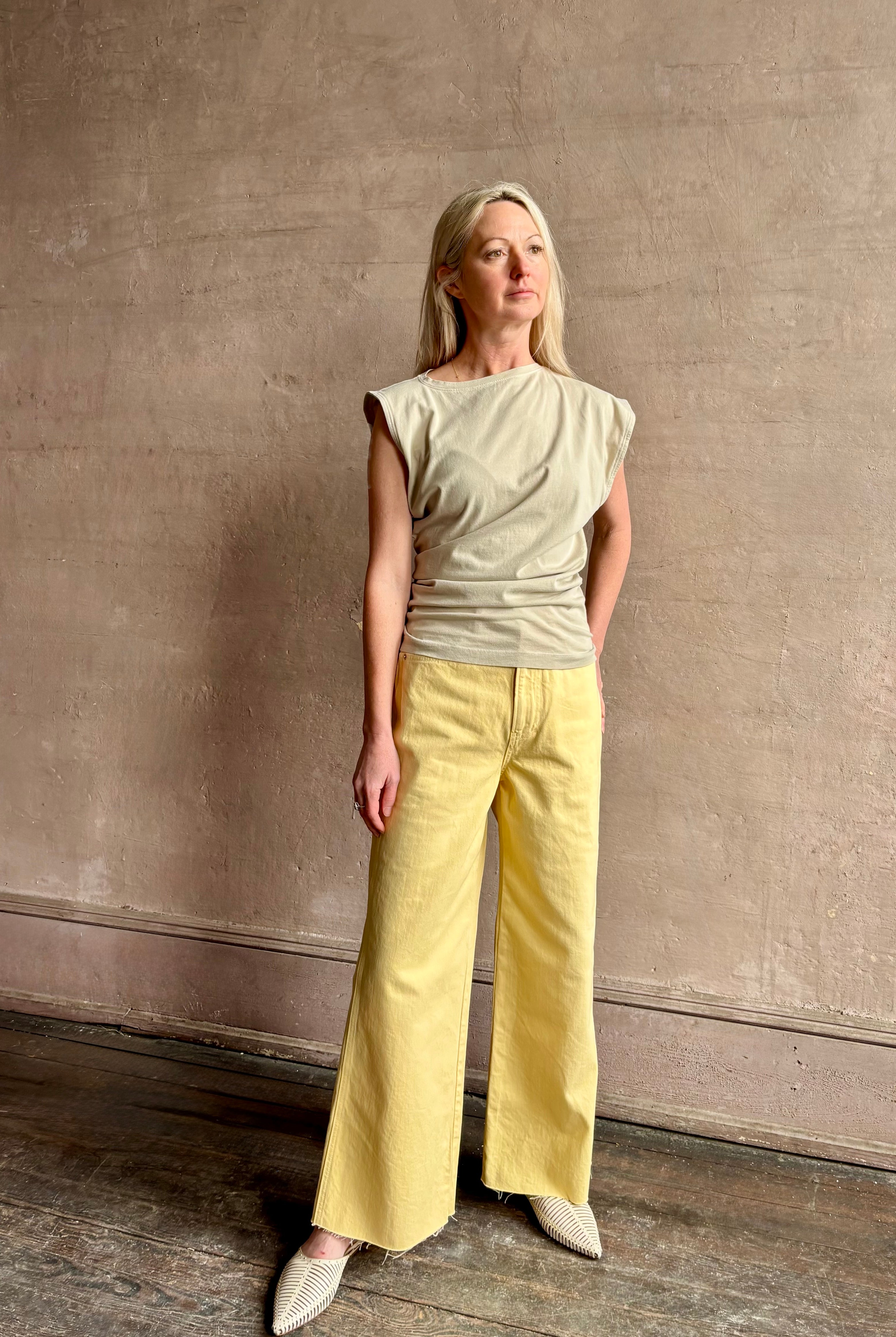 Image of woman wearing - Premium Organic Cotton Luxury Basics AGOLDE Beth Tee in Rice Grass beige with cap sleeves and draping