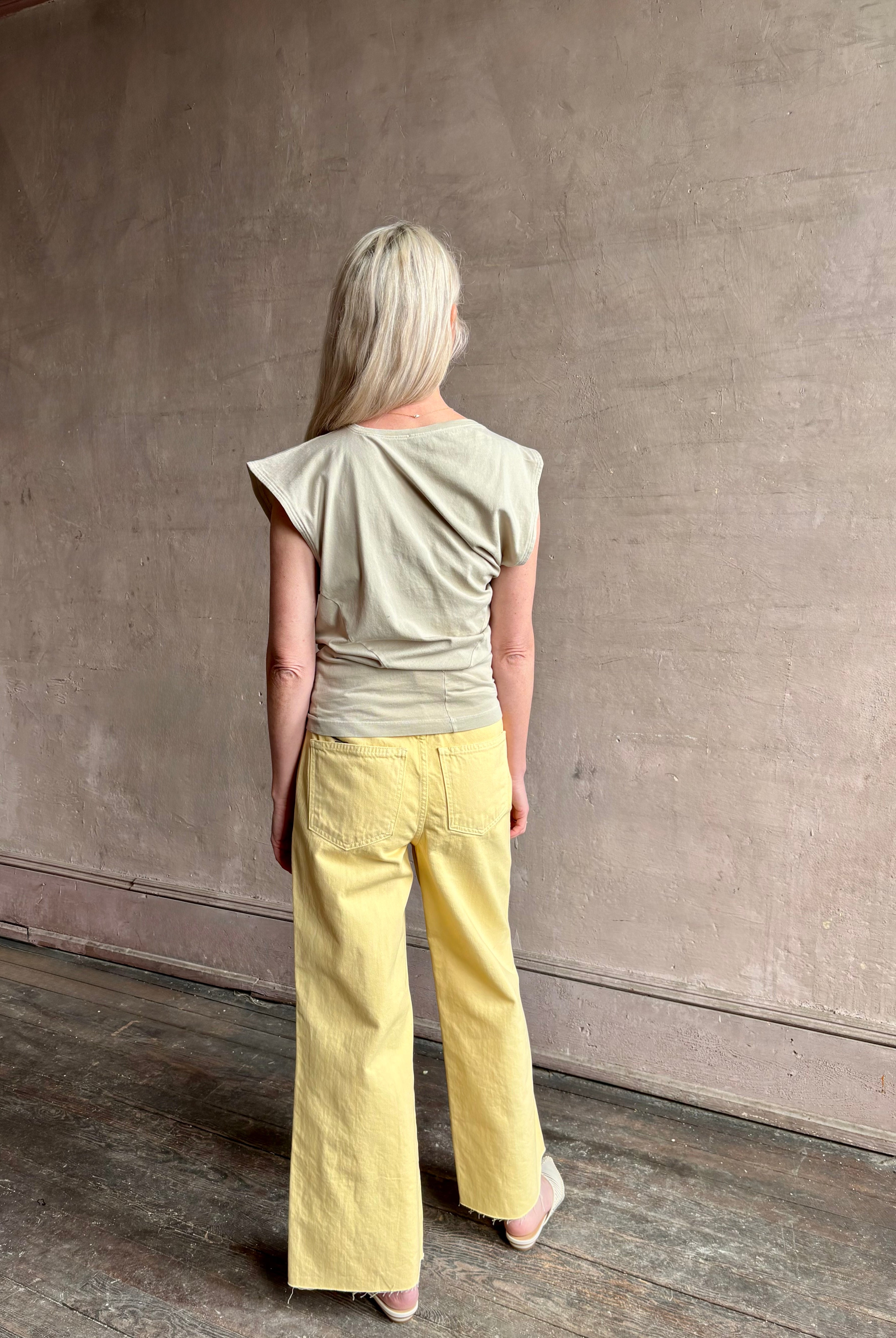 Image of woman wearing - Premium Organic Cotton Luxury Basics AGOLDE Beth Tee in Rice Grass beige with cap sleeves and draping