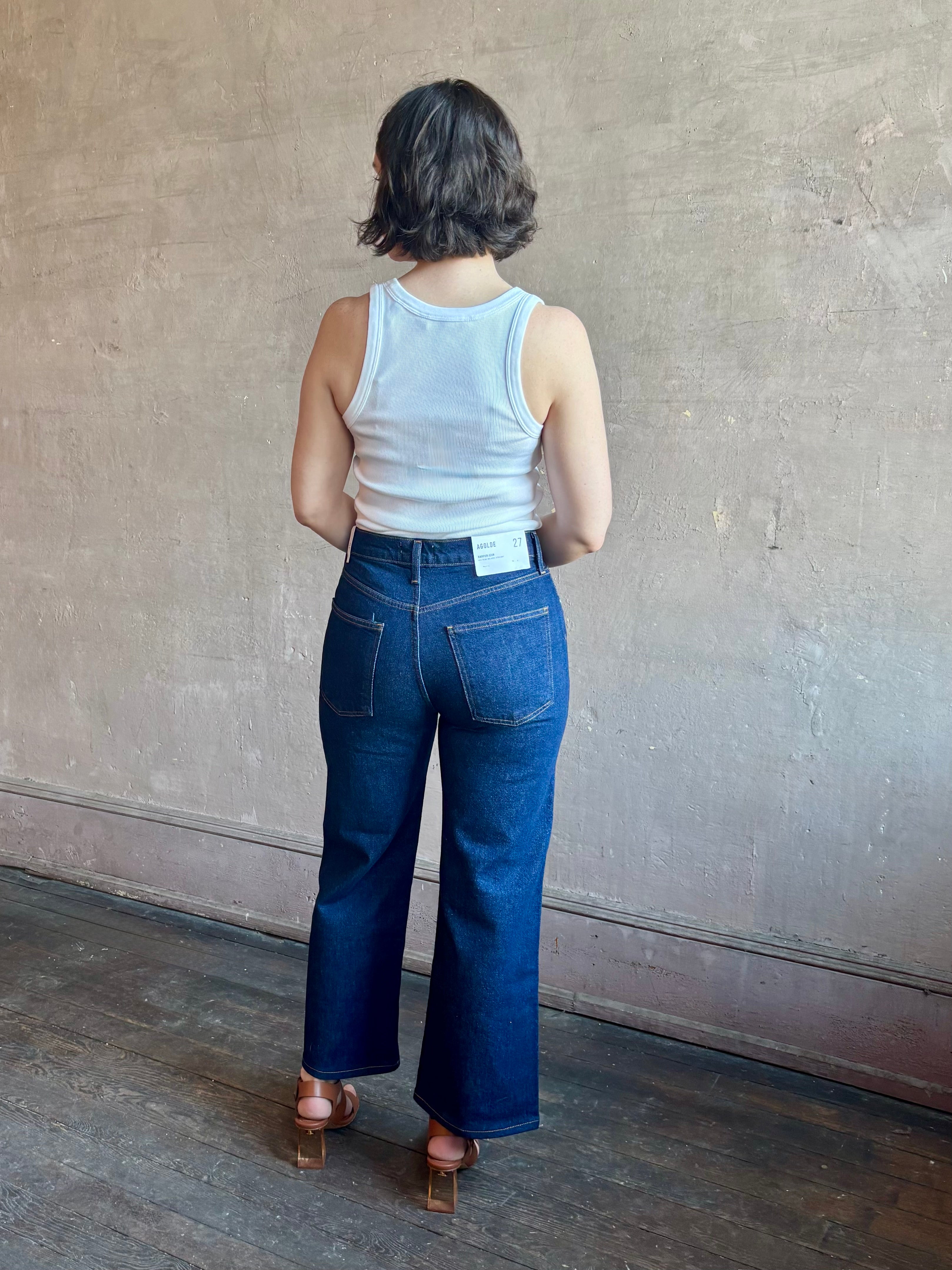 Woman wearing AGOLDE Harper rigid cotton Denim in Reissue dark wash with a cropped finish hem and no distressing