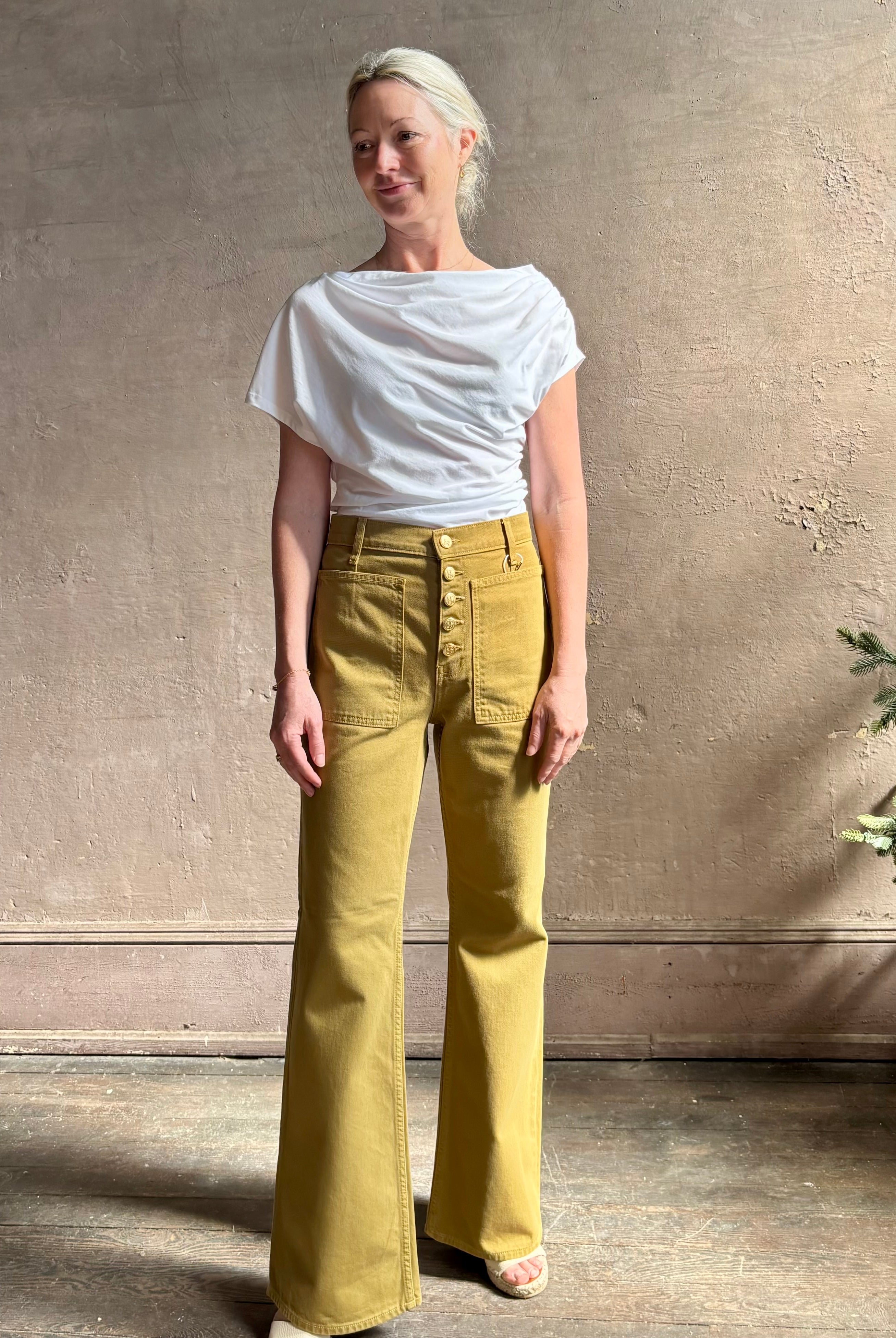 Mature woman wearing ALC Alice cotton t-shirt with ruched side and shoulder detail that can be worn asymmetrically in bright white