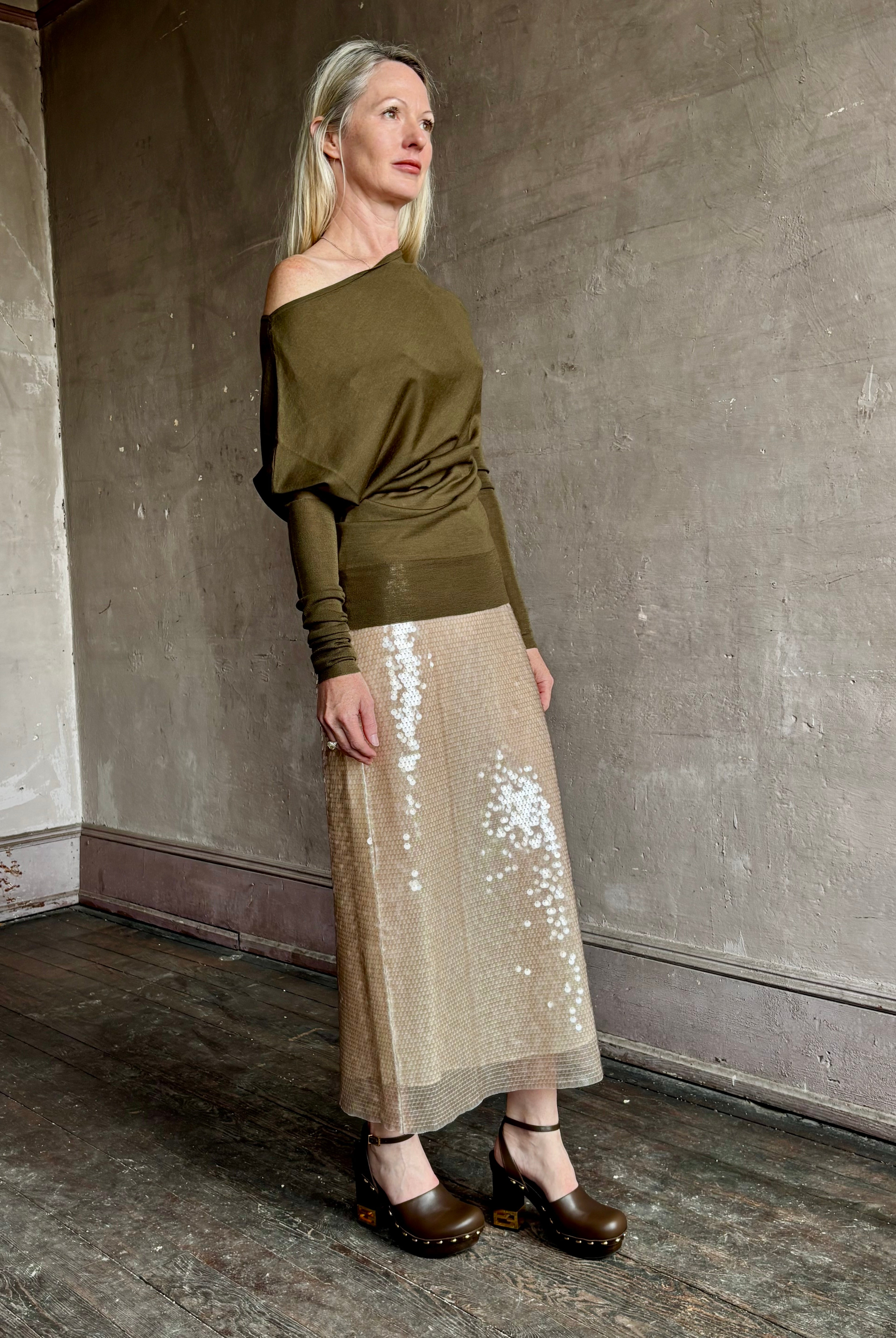 Image of a mature woman wearing contemporary fashion designer ALC Liv Top in an symmetric neckline with off-shoulder draping in army green