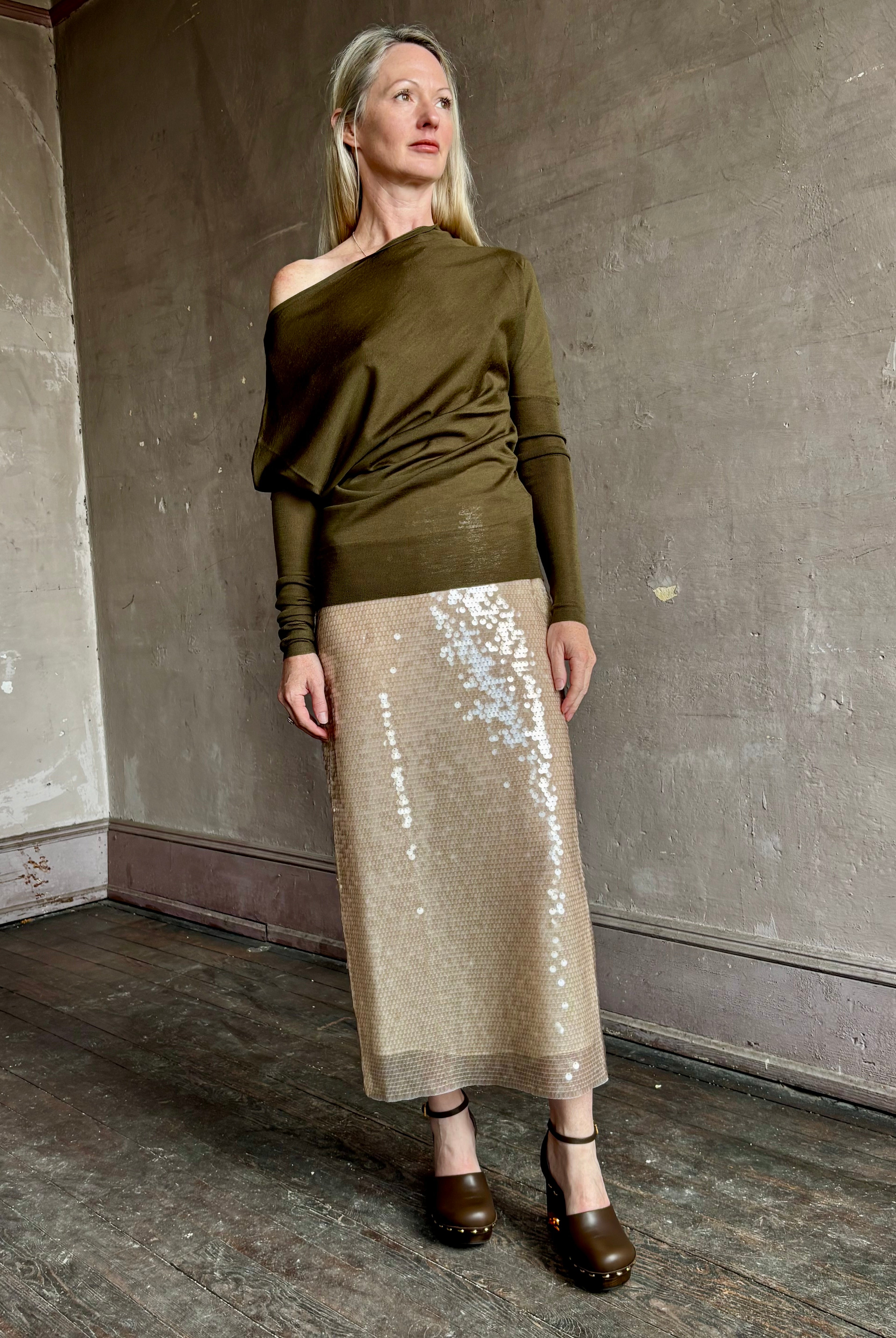 Image of a mature woman wearing contemporary fashion designer ALC Liv Top in an symmetric neckline with off-shoulder draping in army green