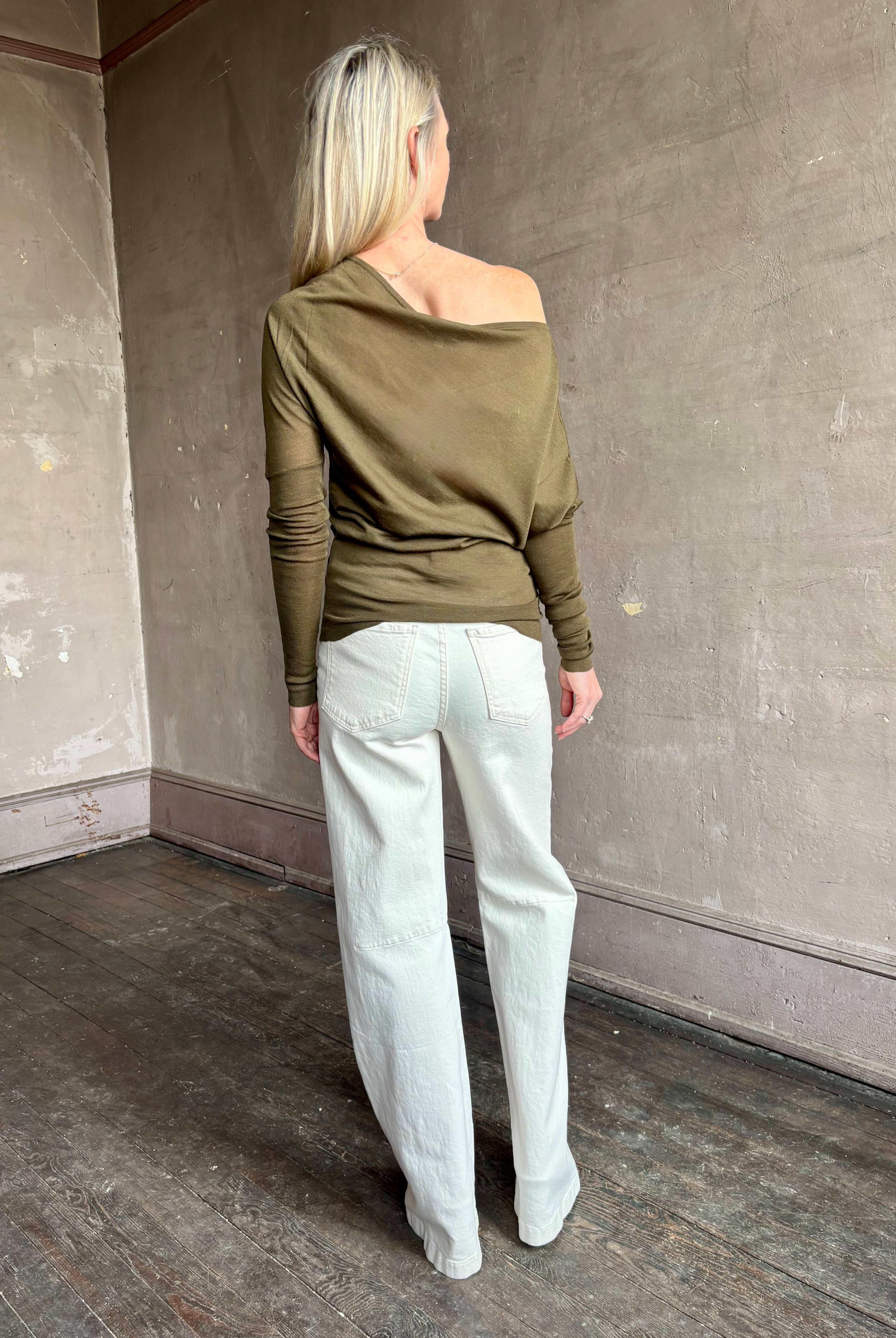 Image of a mature woman wearing contemporary fashion designer ALC Liv Top in an symmetric neckline with off-shoulder draping in army green