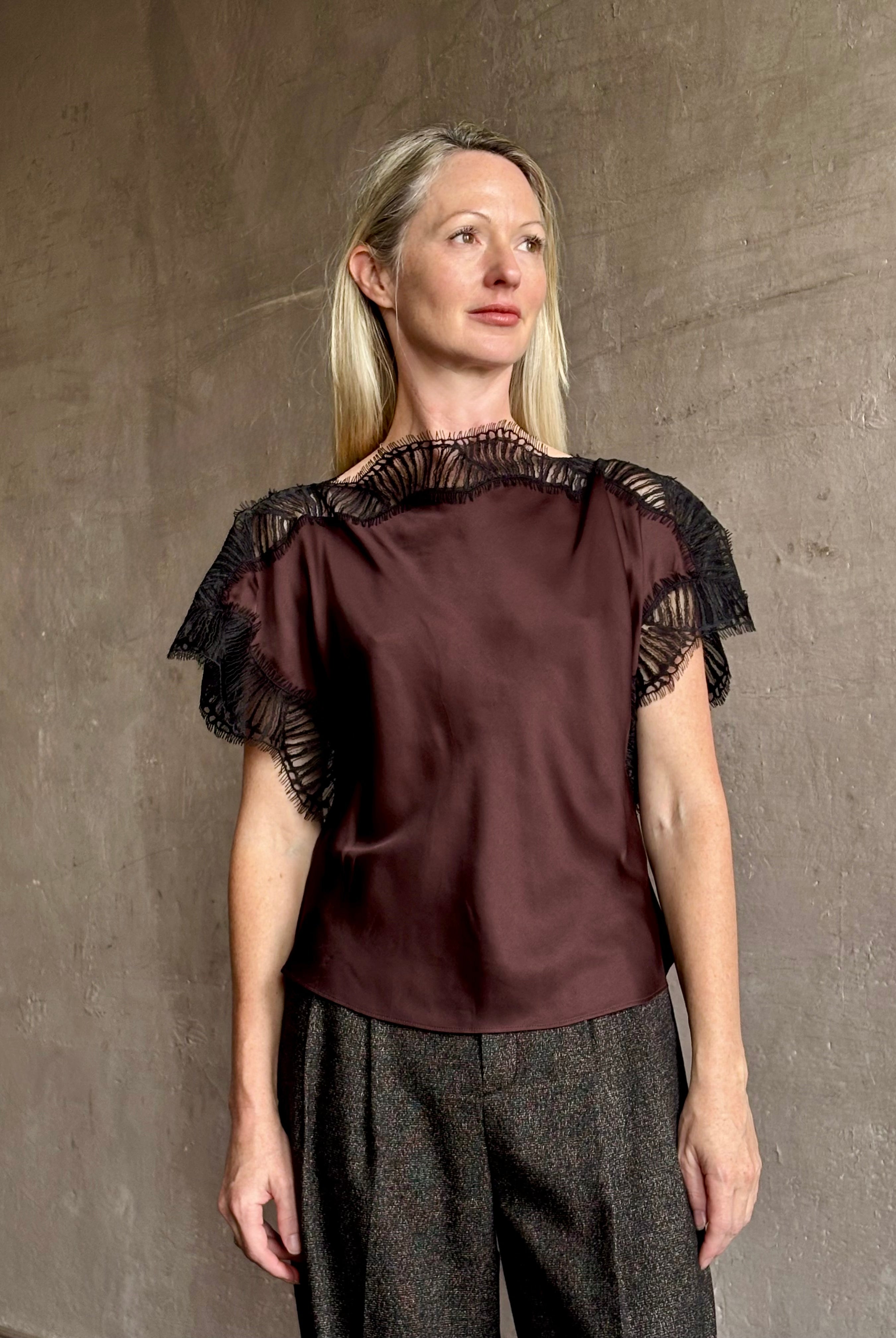 Image of mature woman wearing ALC Luna top in premium chocolate brown viscose blouse with a boat neck short sleeve and refined black lace trim