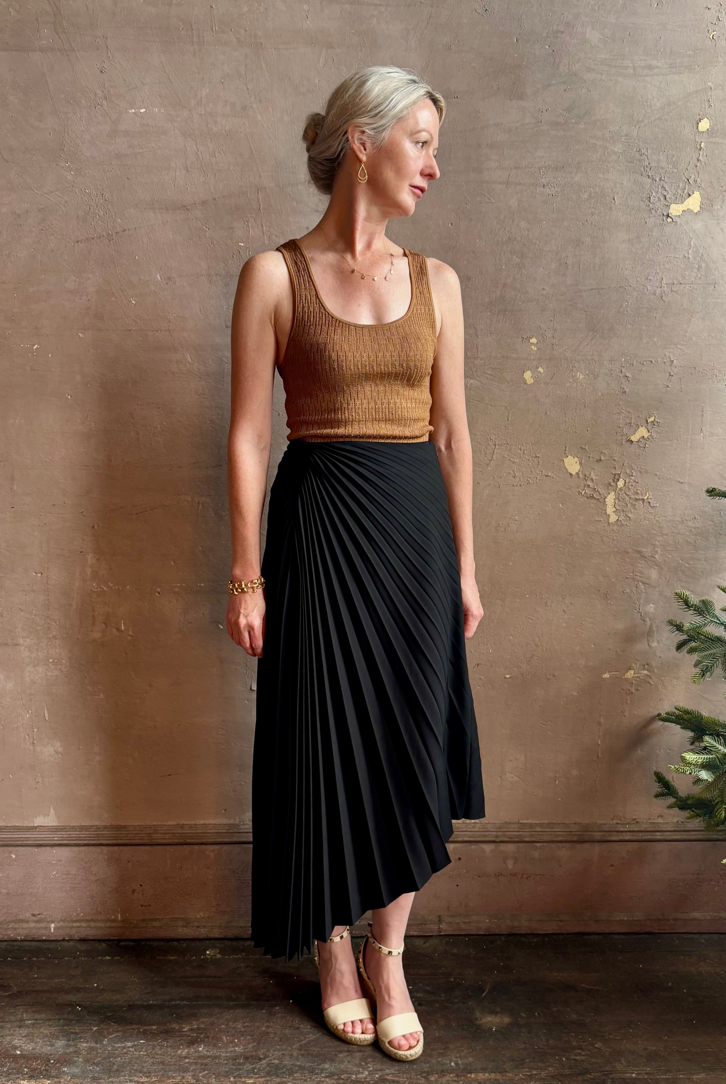 Mature woman wearing ALC Tracy skirt in black wool with asymetrical hemline and pleating