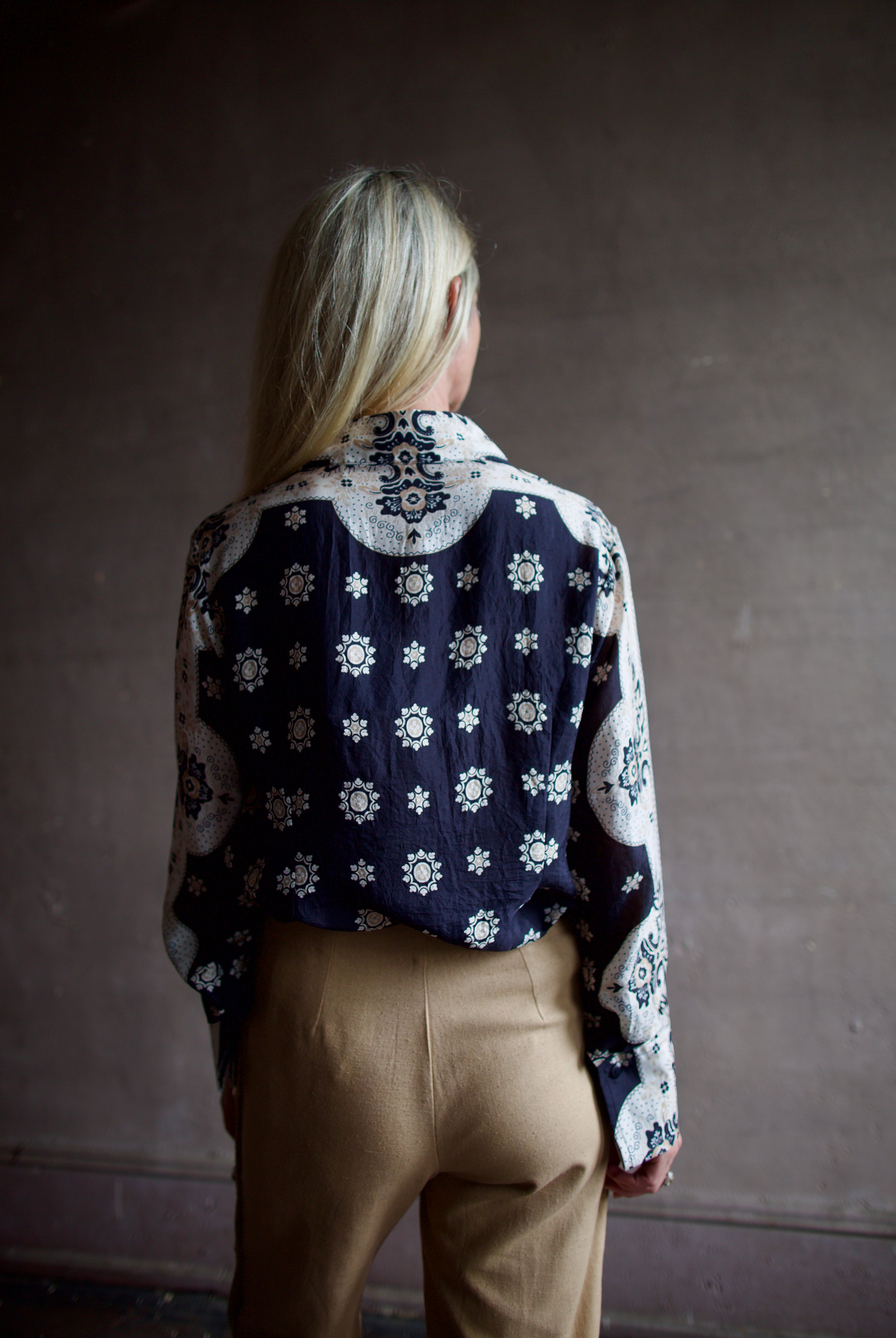 Model wearing an Alix of Bohemia bandana blouse and silk beige Alix trousers
