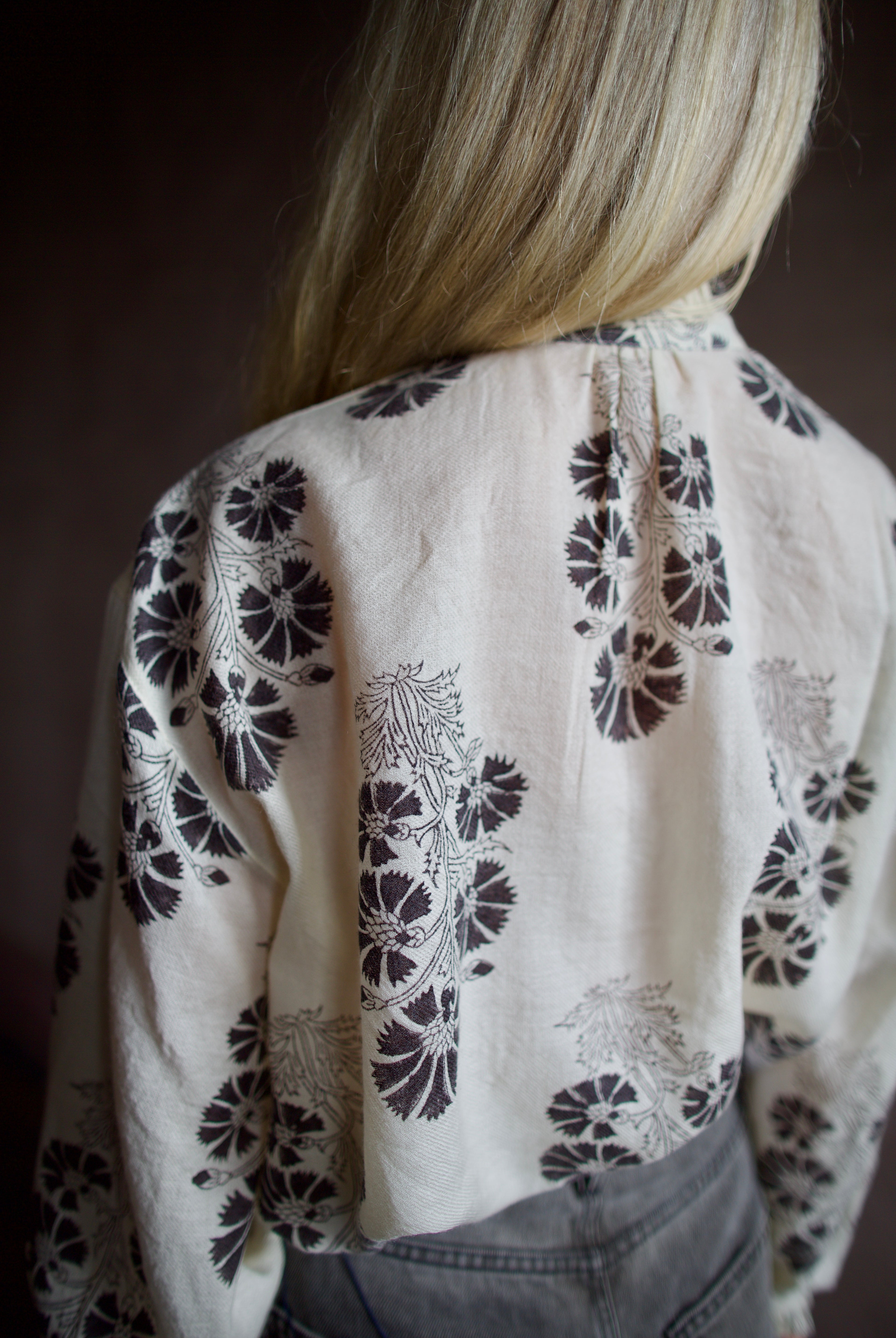 Barck of Poet Alix of Bohemia wool floral blouse and Veronica Beard high-waisted grey barrel jeans.