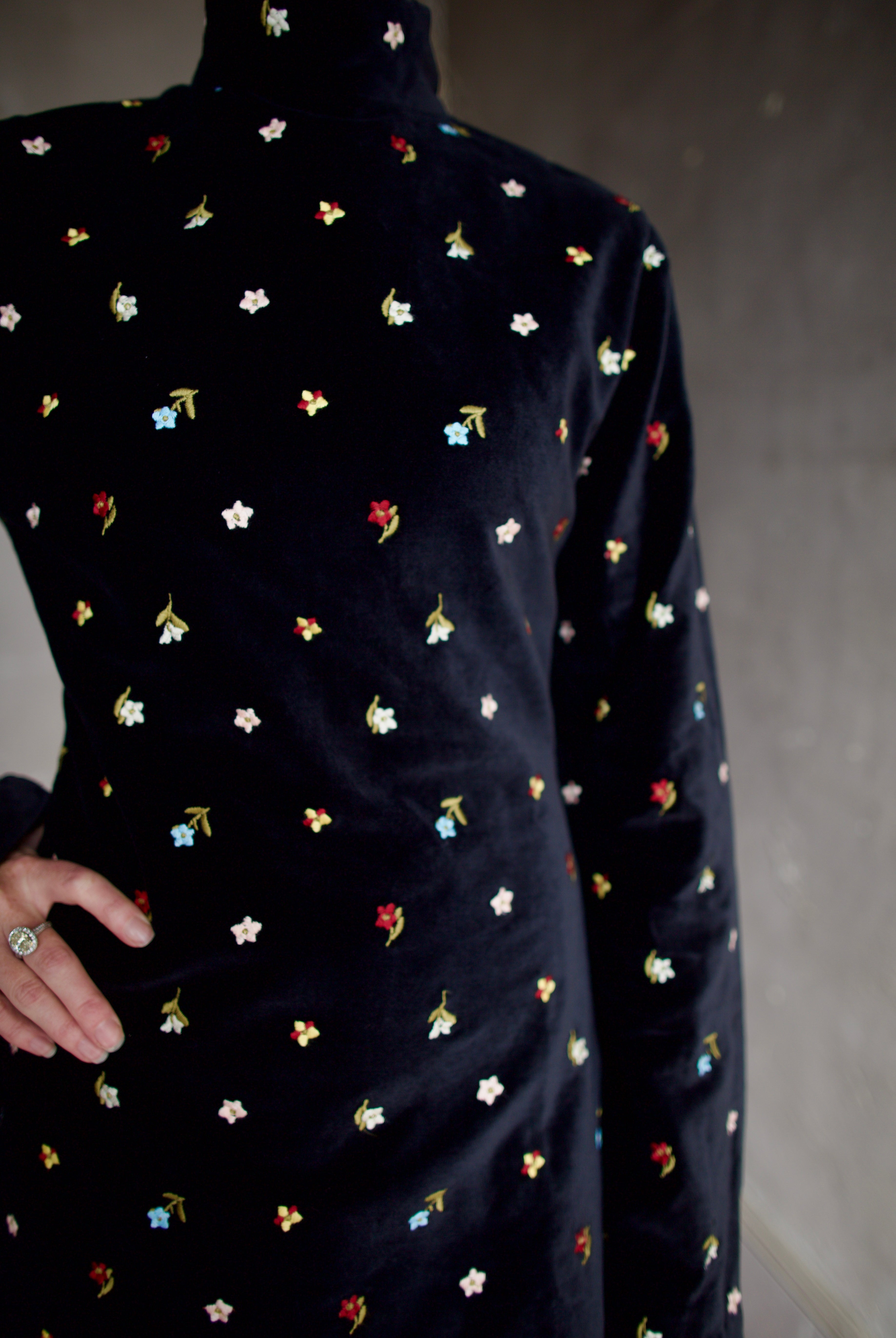 Model wearing Alix of Bohemia Romy Onyx Bouquet Dress. Premium cotton construction of black mini dress with flower bud details with luxurious silk-blend lining.