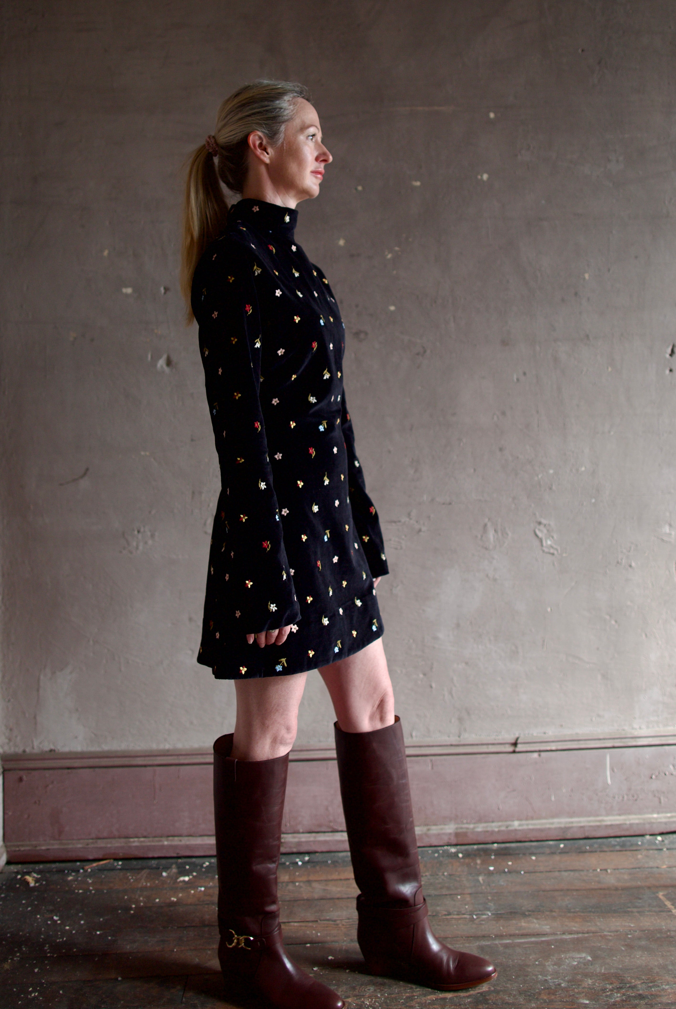 Model wearing Alix of Bohemia Romy Onyx Bouquet Dress. Premium cotton construction of black mini dress with flower bud details with luxurious silk-blend lining.