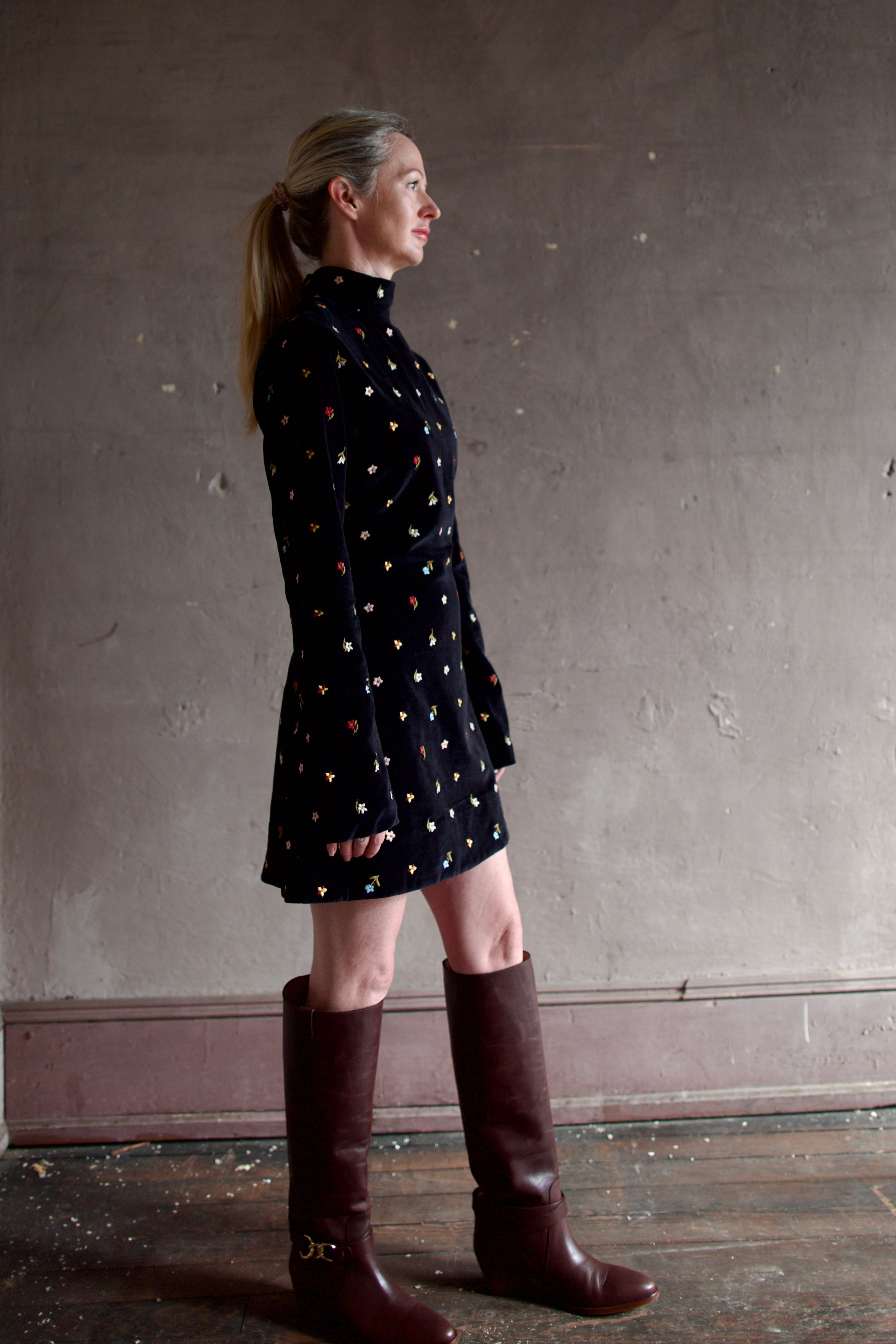 Model wearing Alix of Bohemia Romy Onyx Bouquet Dress. Premium cotton construction of black mini dress with flower bud details with luxurious silk-blend lining.