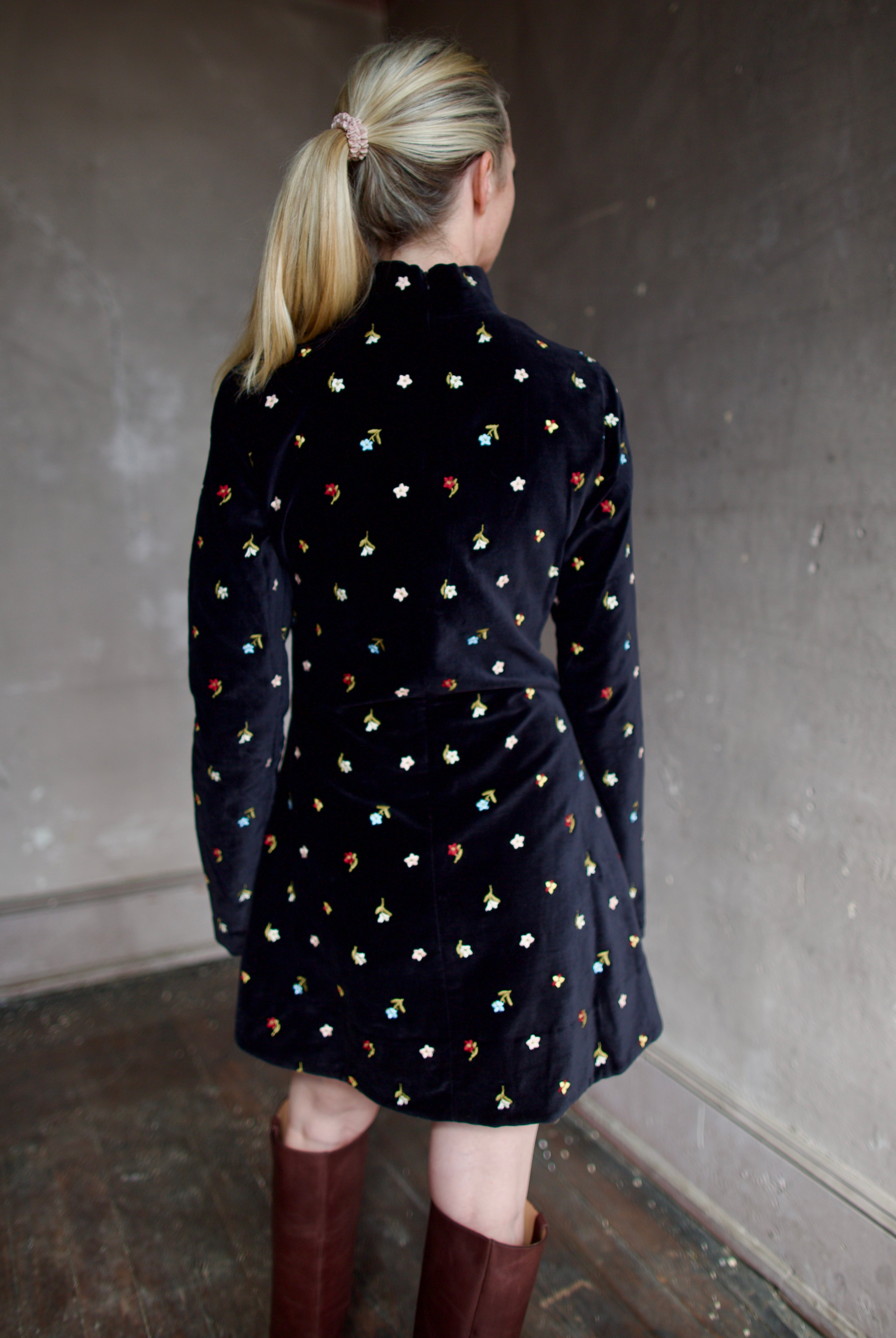 Model wearing Alix of Bohemia Romy Onyx Bouquet Dress. Premium cotton construction of black mini dress with flower bud details with luxurious silk-blend lining.