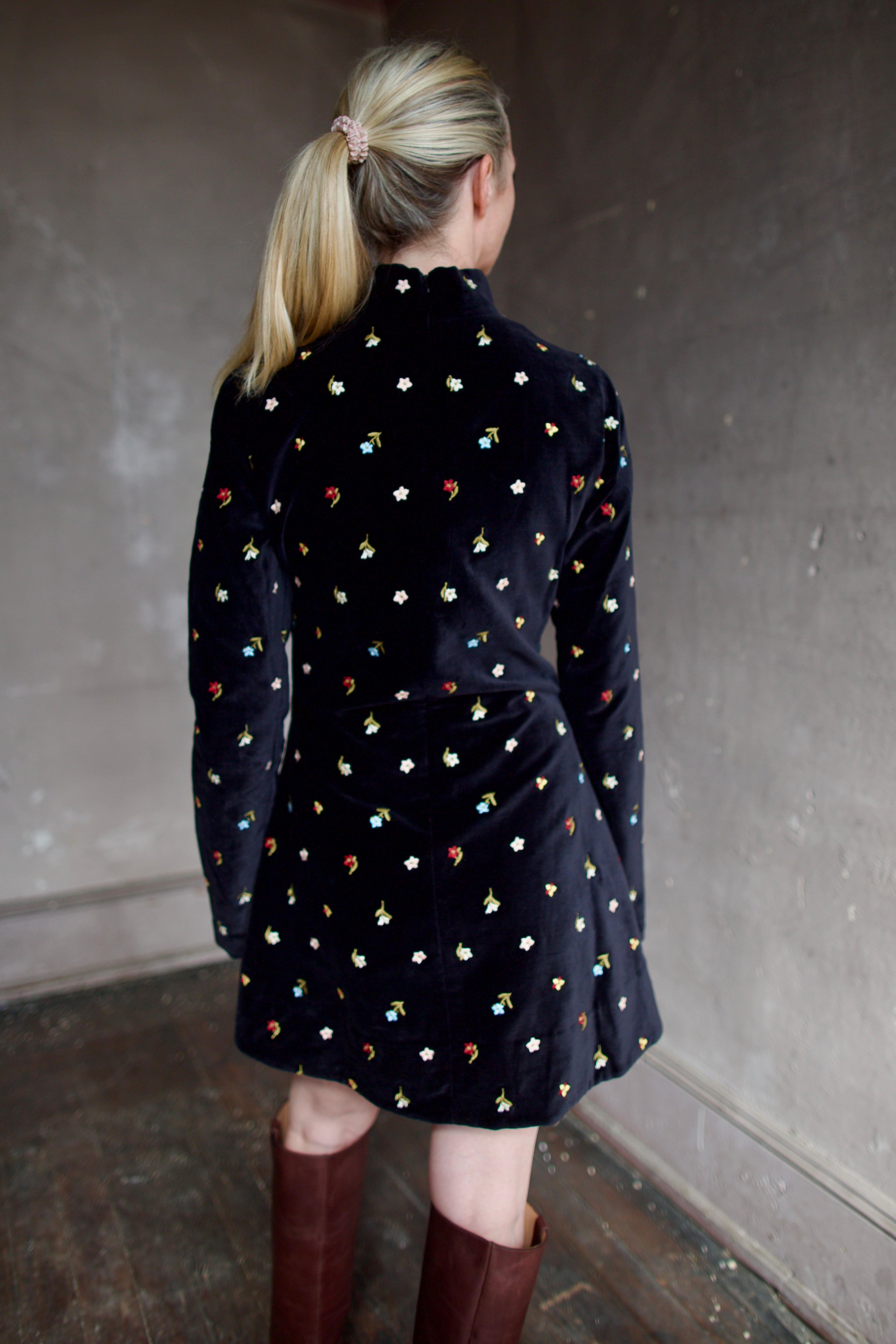 Model wearing Alix of Bohemia Romy Onyx Bouquet Dress. Premium cotton construction of black mini dress with flower bud details with luxurious silk-blend lining.