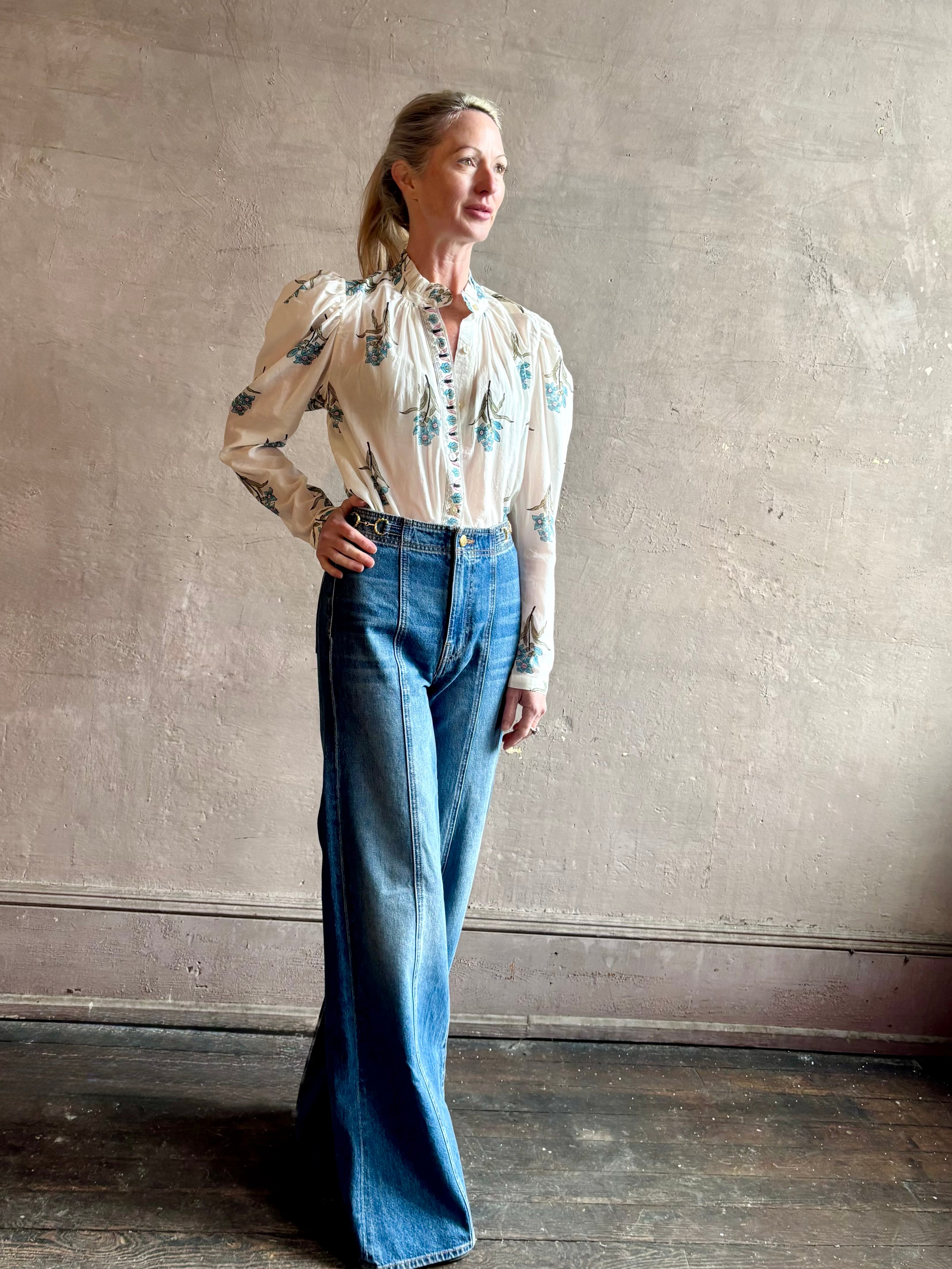 Image of woman wearing ALIX OF BOHEMIA Artemis Sky Mist Flower Shirt with long sleeves and delicate ruffle at neckline