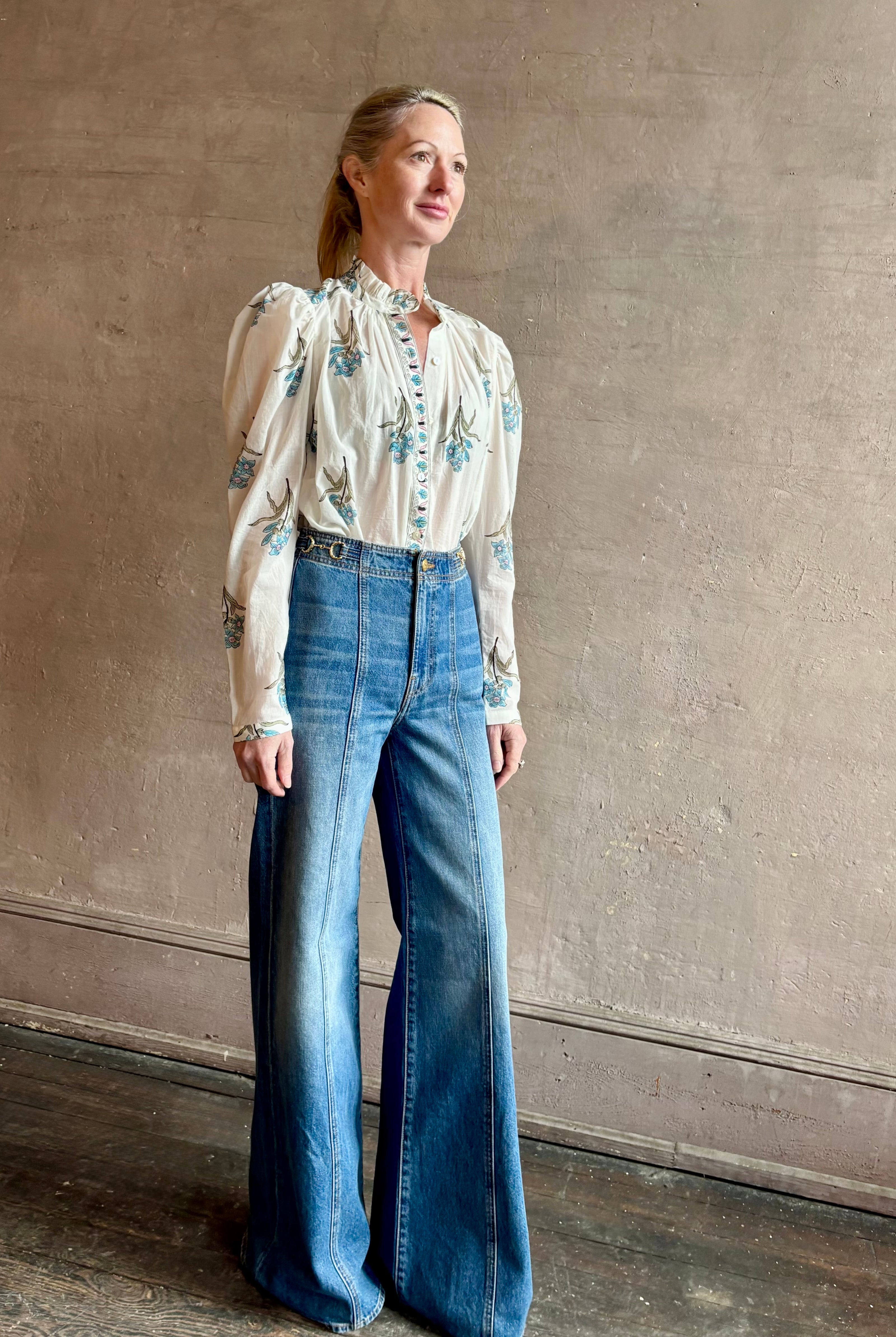 Image of woman wearing ALIX OF BOHEMIA Artemis Sky Mist Flower Shirt with Off-White background and aqua and pink floral print