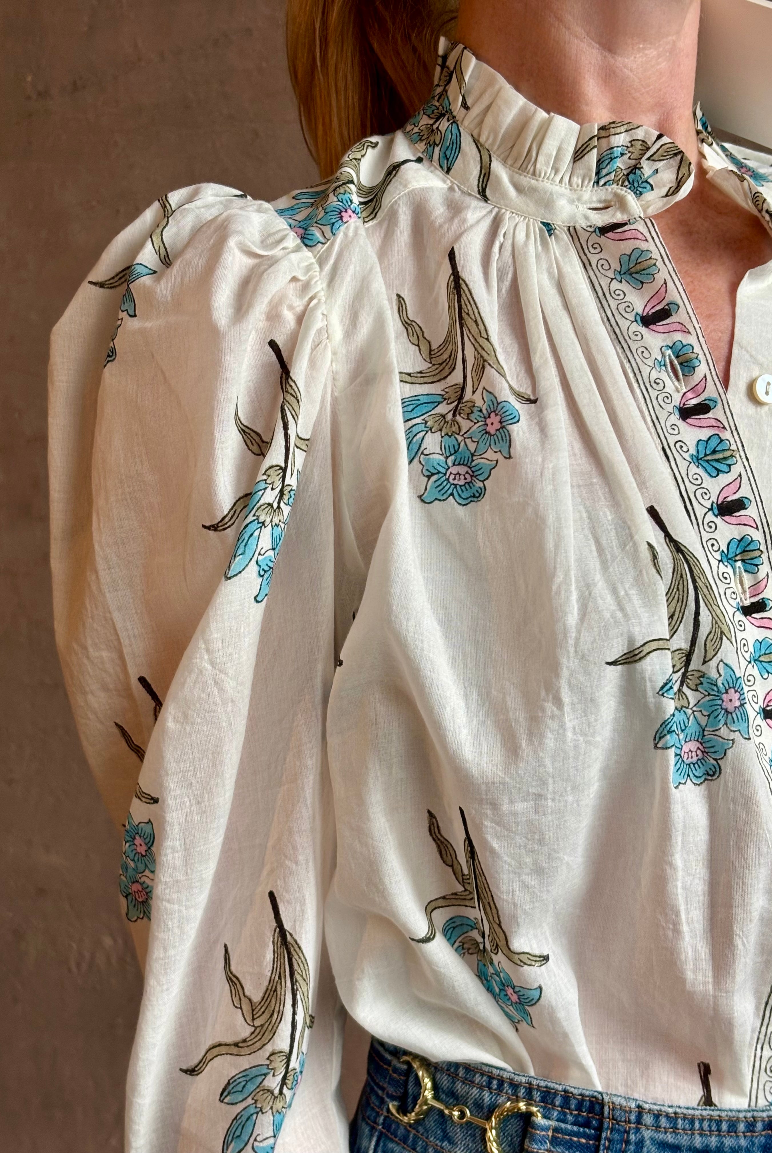 Image of woman wearing ALIX OF BOHEMIA Artemis Sky Mist Flower Shirt with Off-White background and aqua and pink floral print