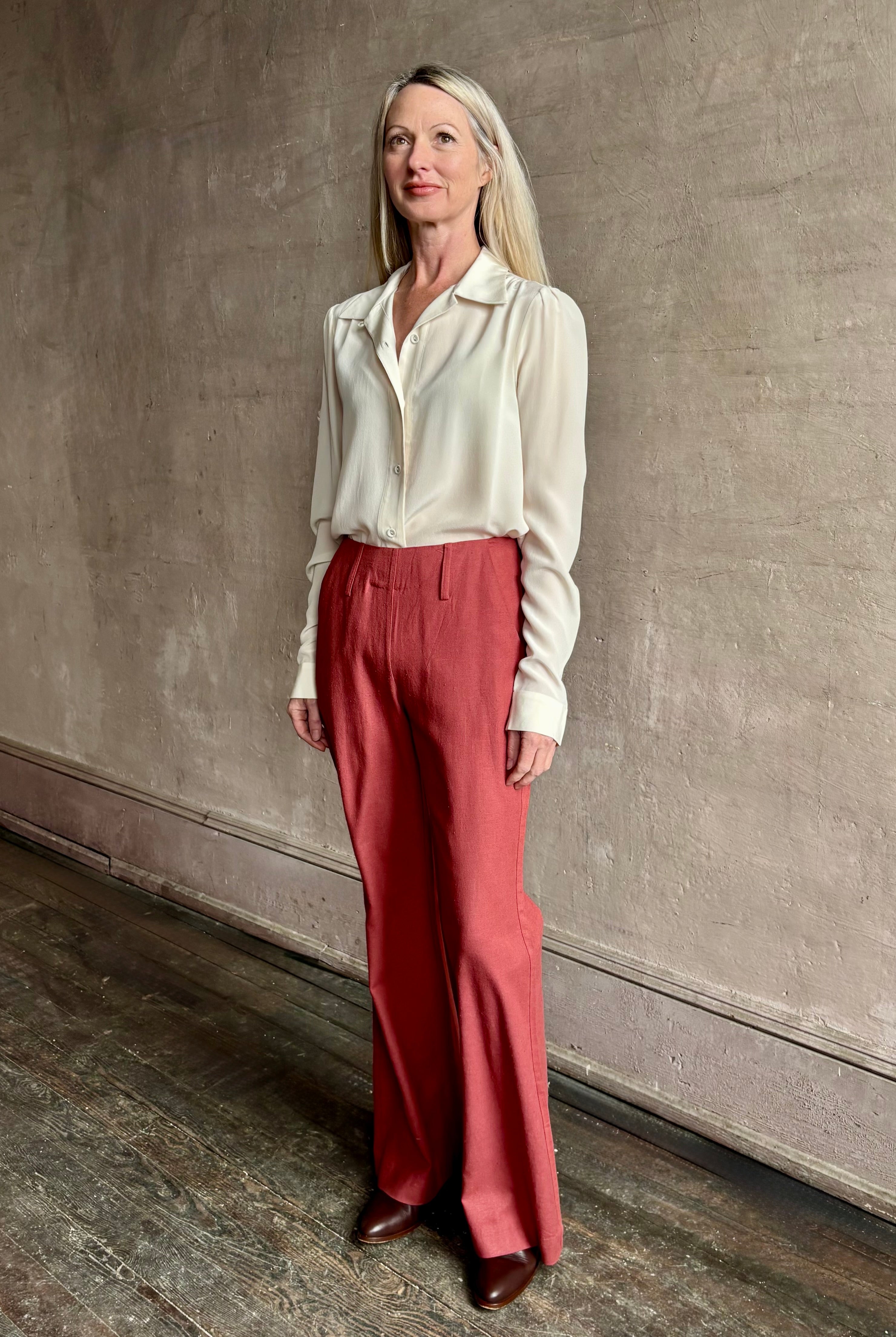 Woman wearing sophisticated ALIX OF BOHEMIA Charlie Red Ochre Silk Pant with belt loops, flat front and full length straight leg
