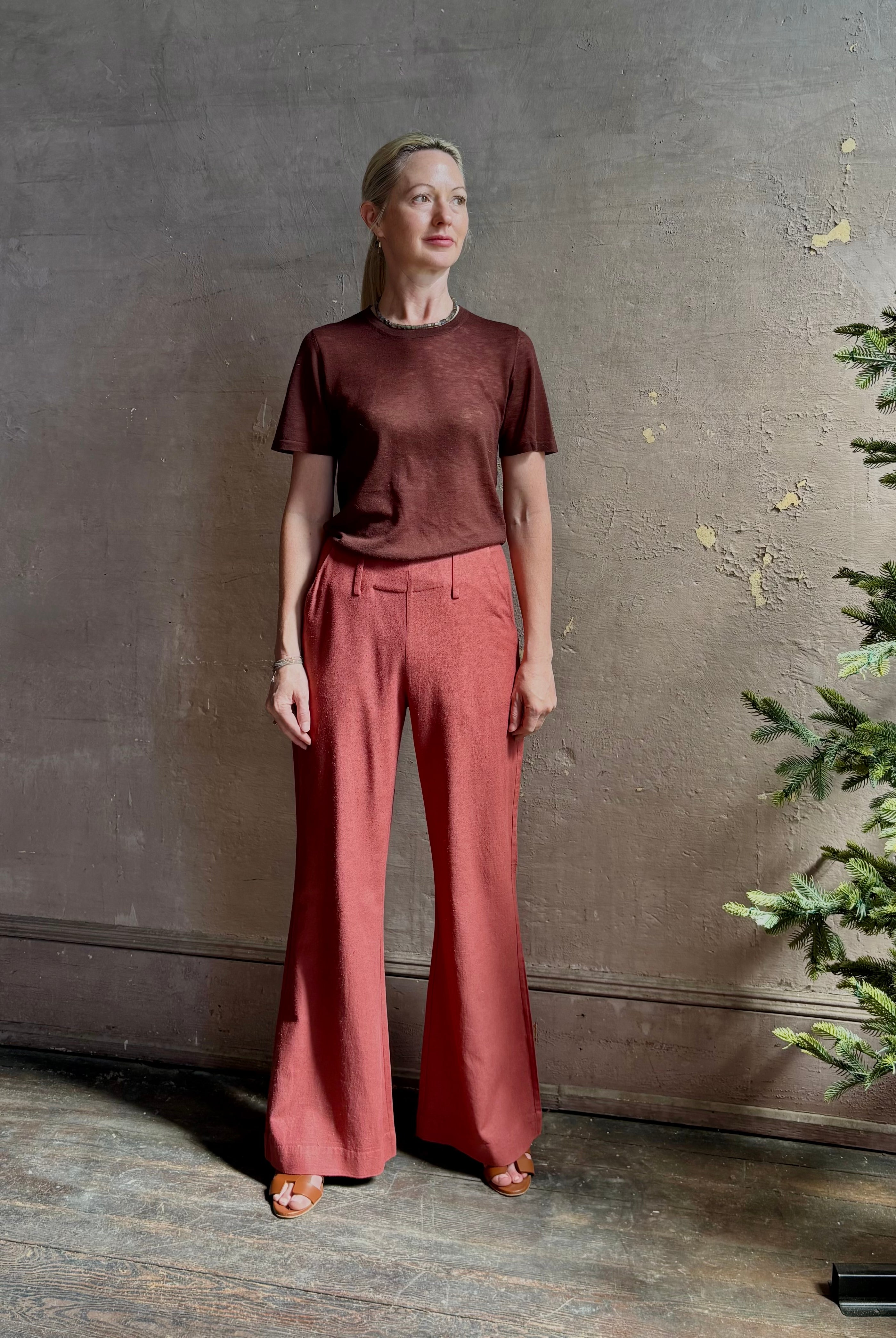 Woman wearing sophisticated ALIX OF BOHEMIA Charlie Red Ochre Silk mid-rise Pant with front and back pockets, belt loops, flat front and full length straight leg