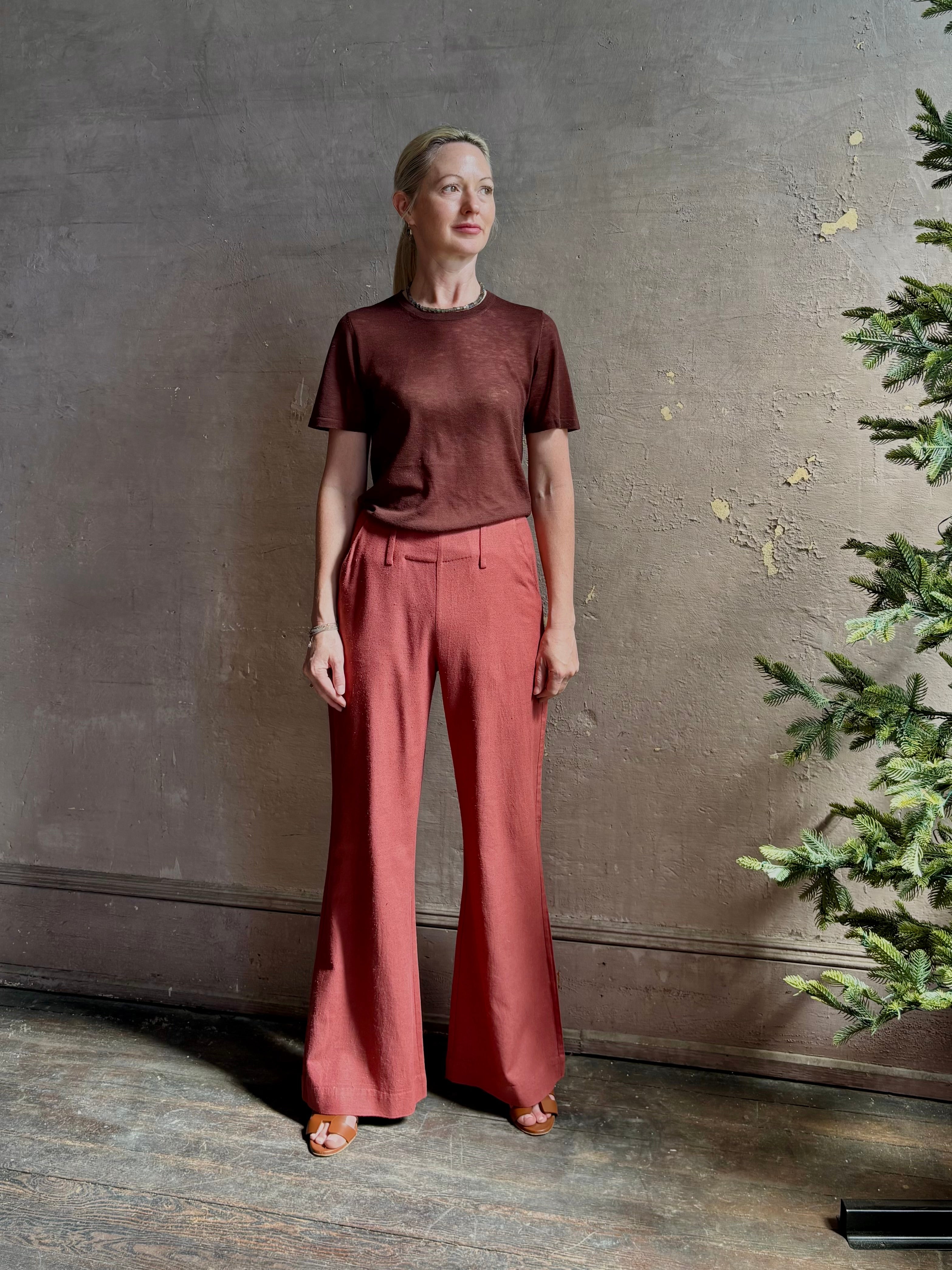 Woman wearing sophisticated ALIX OF BOHEMIA Charlie Red Ochre Silk mid-rise Pant with front and back pockets, belt loops, flat front and full length straight leg