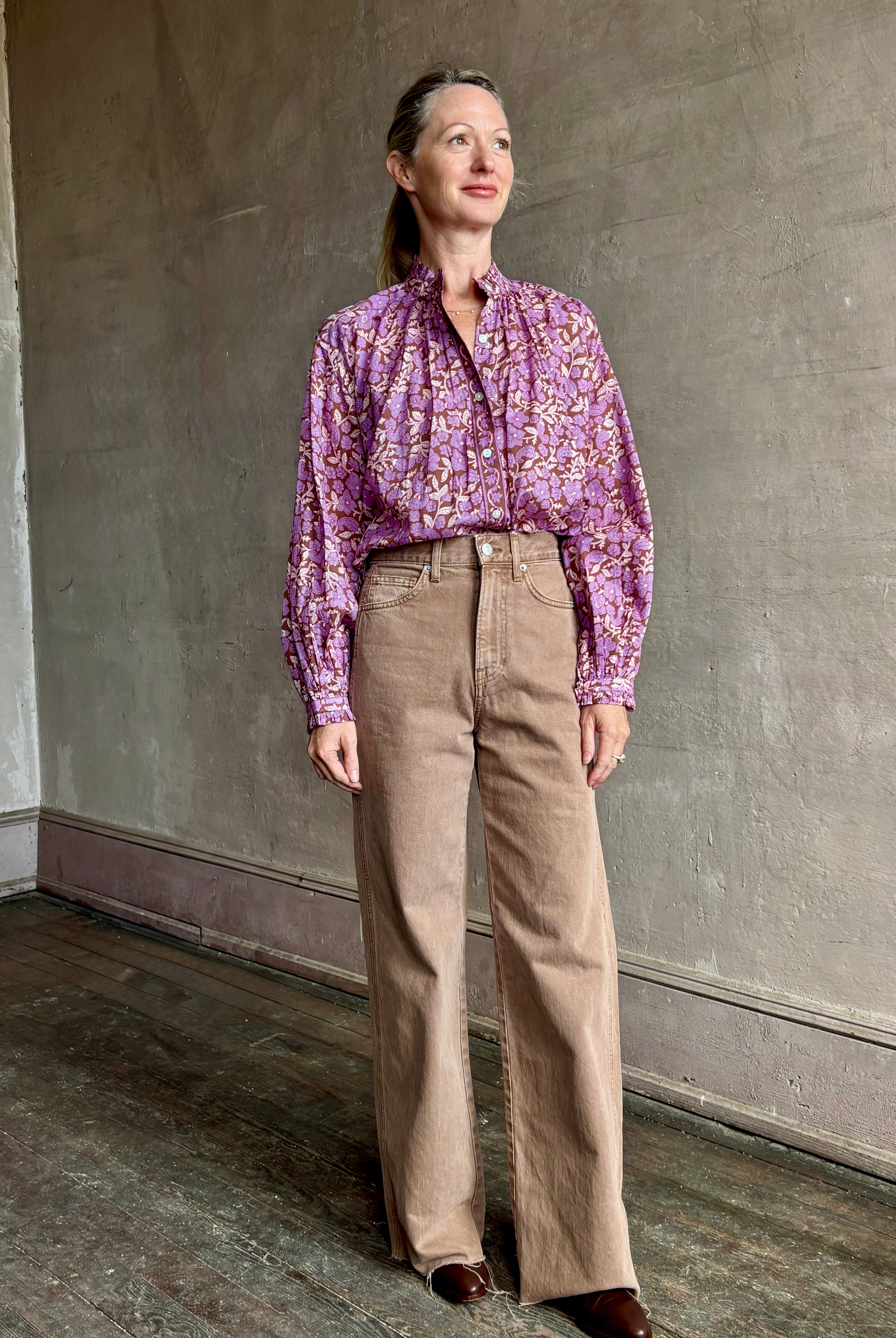 Image of woman wearing Alix of Bohemia feminine purple blouse with mandarin collar styling and delicate ruffle accents in a small floral print