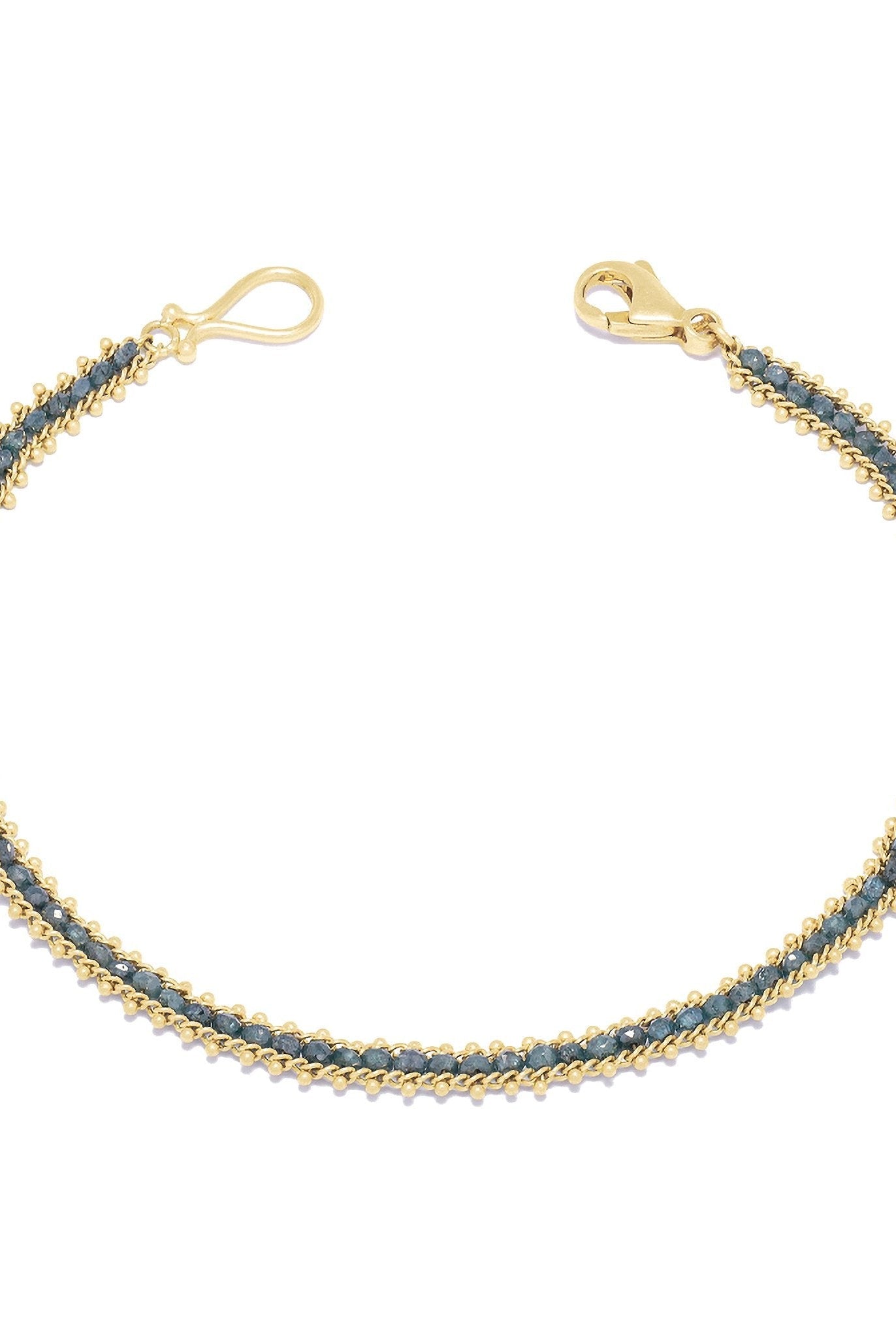 Image of the vivid natural blue diamond row bracelet designed by NC fine jeweler Amali in warm 18K yellow gold