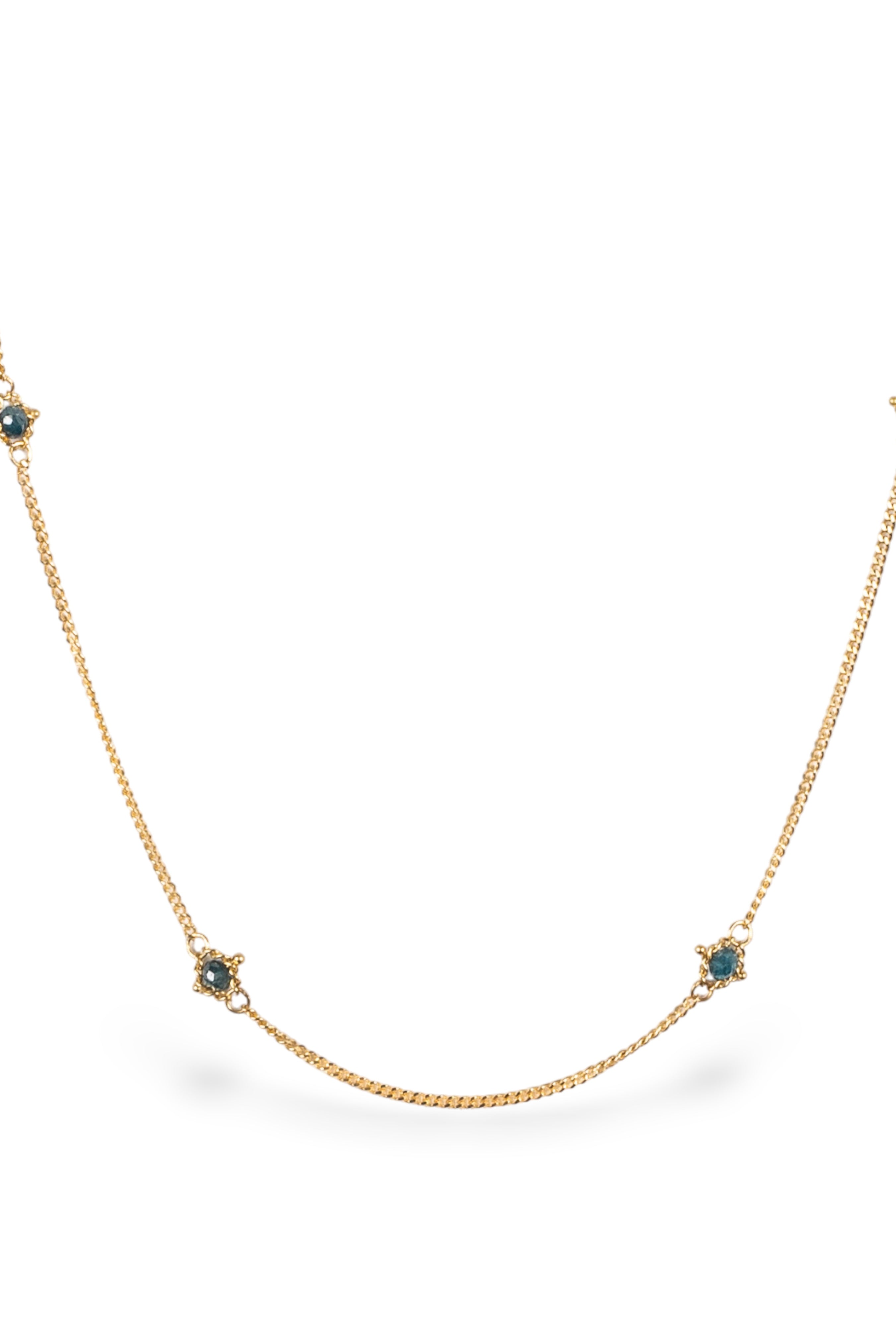 Close up image of a natural blue diamond chain necklace handcrafted by North Carolina fine jewelry designer Amali in warm 18K yellow gold with a refreshing contemporary design