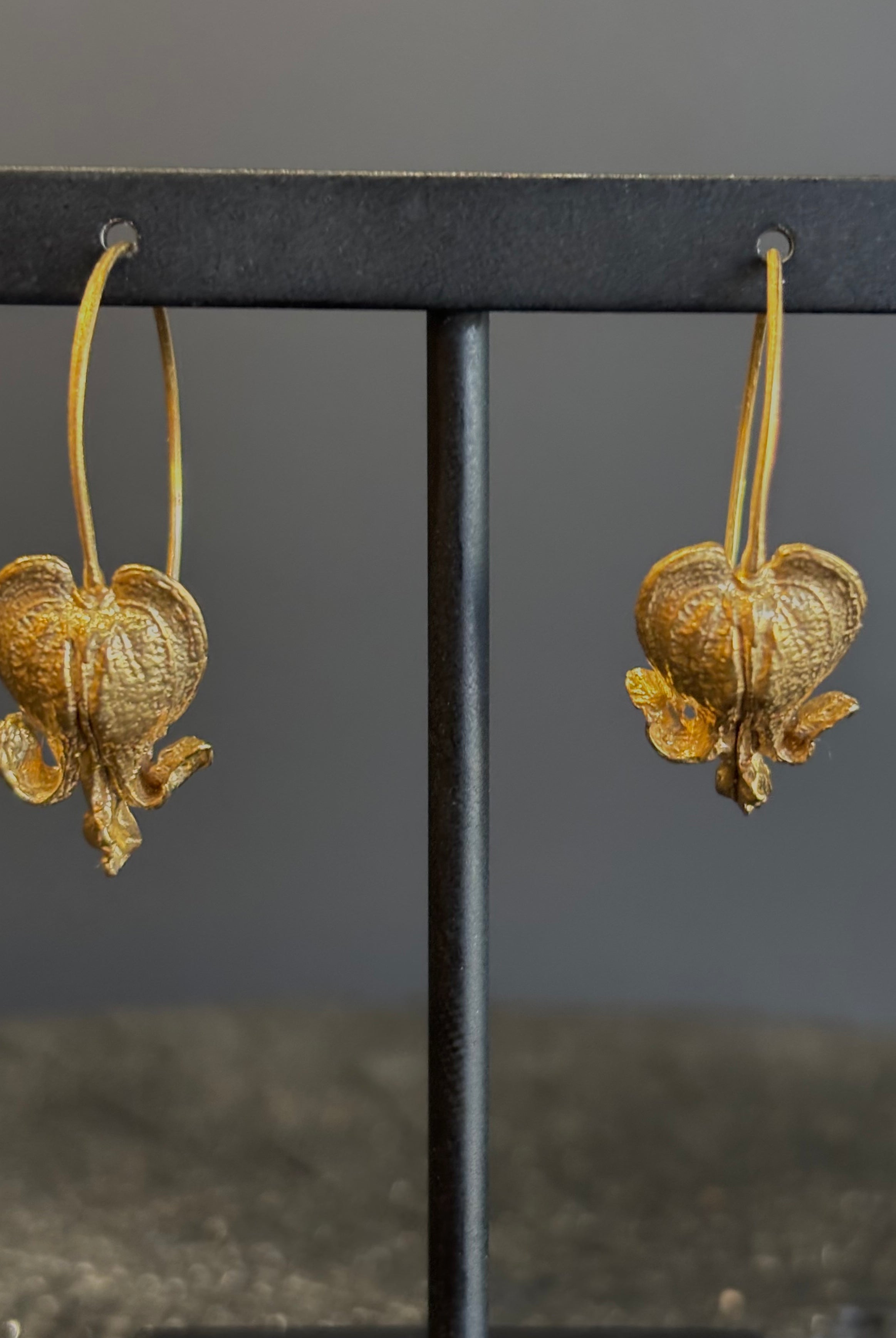 Image of Bleeding Heart Hoop Earrings from North Carolina fine Jewelry artist Amber Mahler handcrafted 18K yellow gold vermeil botanical casting.