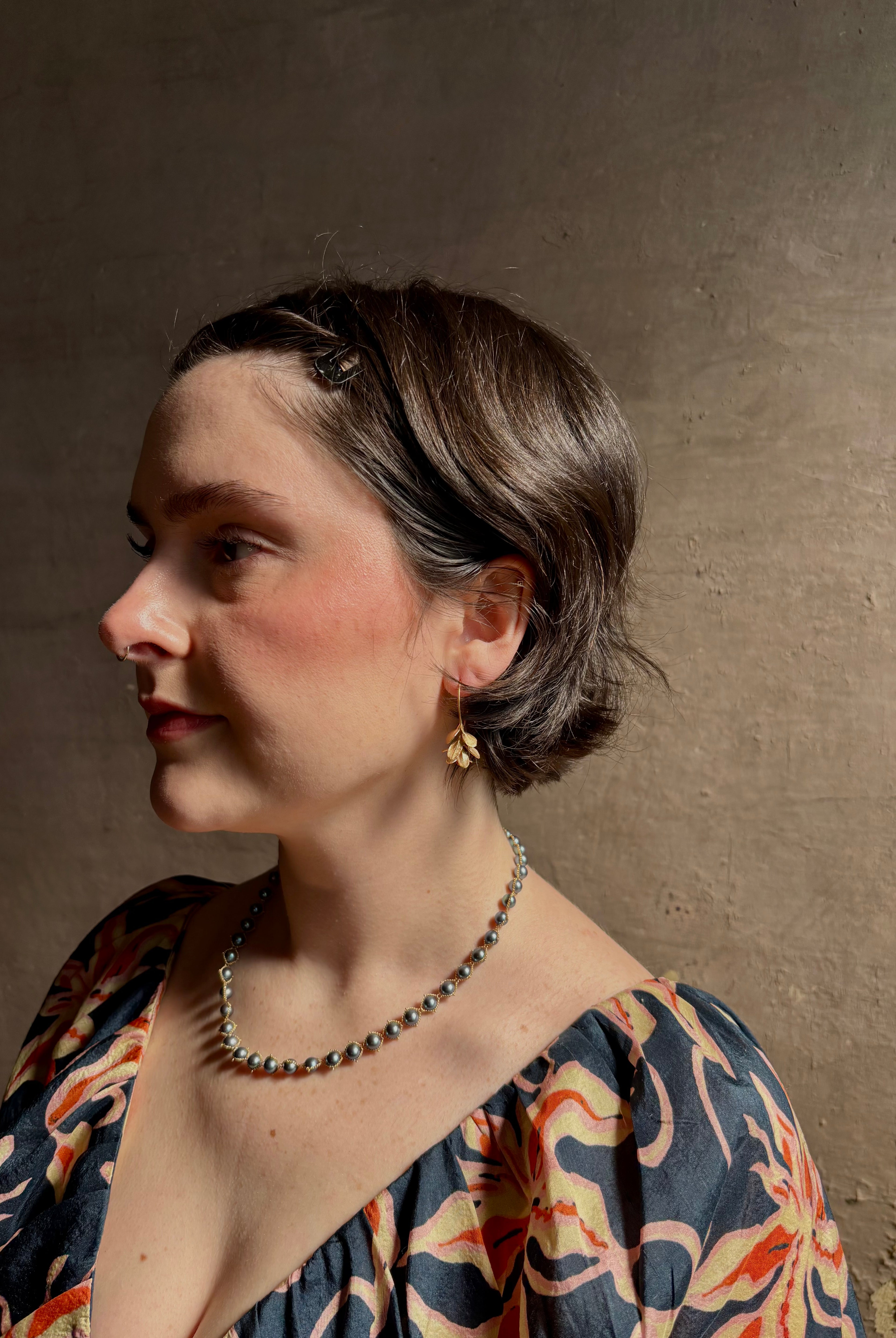 Woman wearing Four Petal Succulent Hoop Earrings from North Carolina fine jewelry artist Amber Mahler handcrafted 18K yellow gold vermeil botanical casting