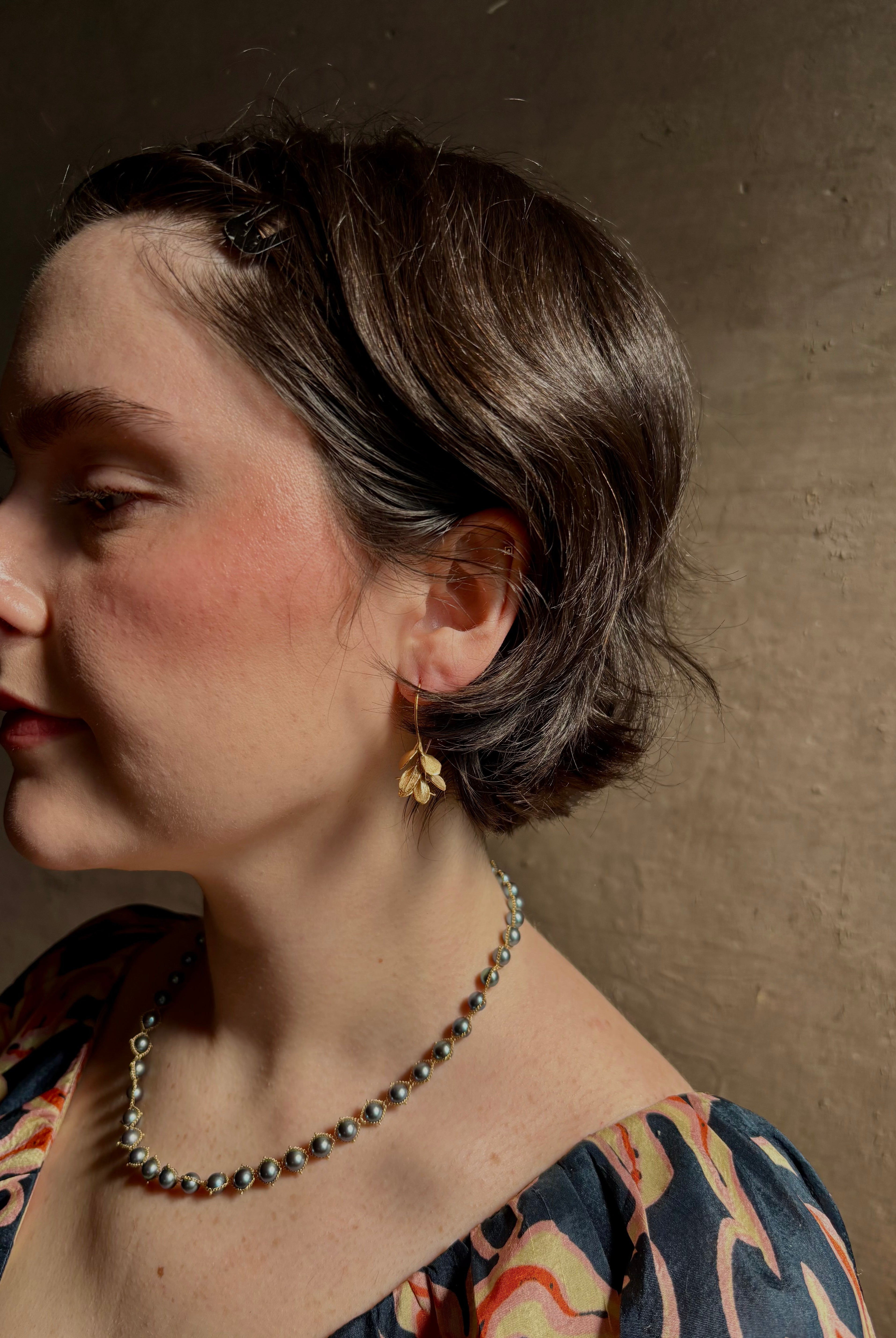 Woman wearing Four Petal Succulent Hoop Earrings from North Carolina fine jewelry artist Amber Mahler handcrafted 18K yellow gold vermeil botanical casting