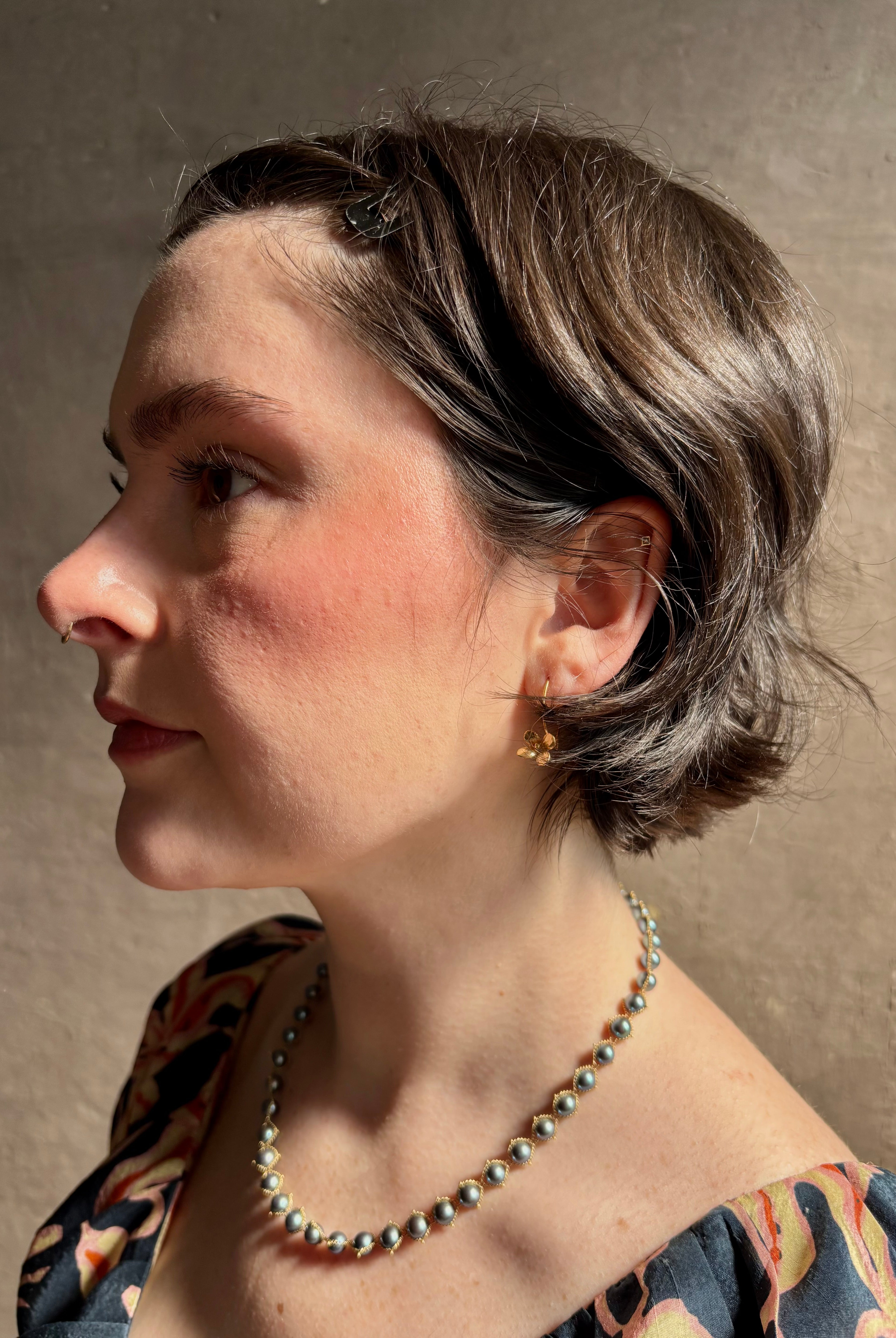 Woman wearing Purslane Rosette Hoop Earrings from North Carolina fine jewelry artist Amber Mahler handcrafted in 18K yellow gold vermeil cast directly from the purslane rosette