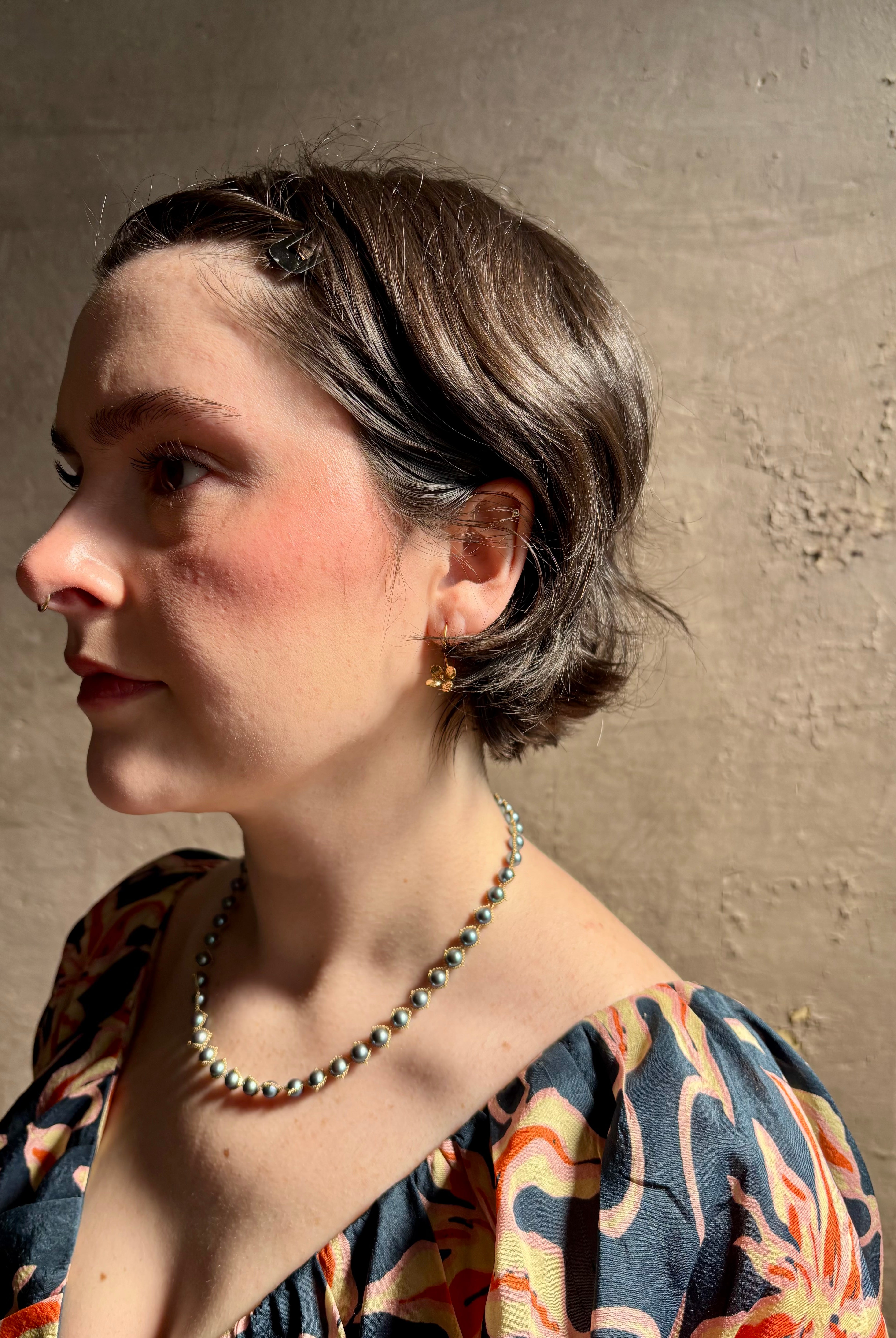 Woman wearing Purslane Rosette Hoop Earrings from North Carolina fine jewelry artist Amber Mahler handcrafted in 18K yellow gold vermeil cast directly from the purslane rosette