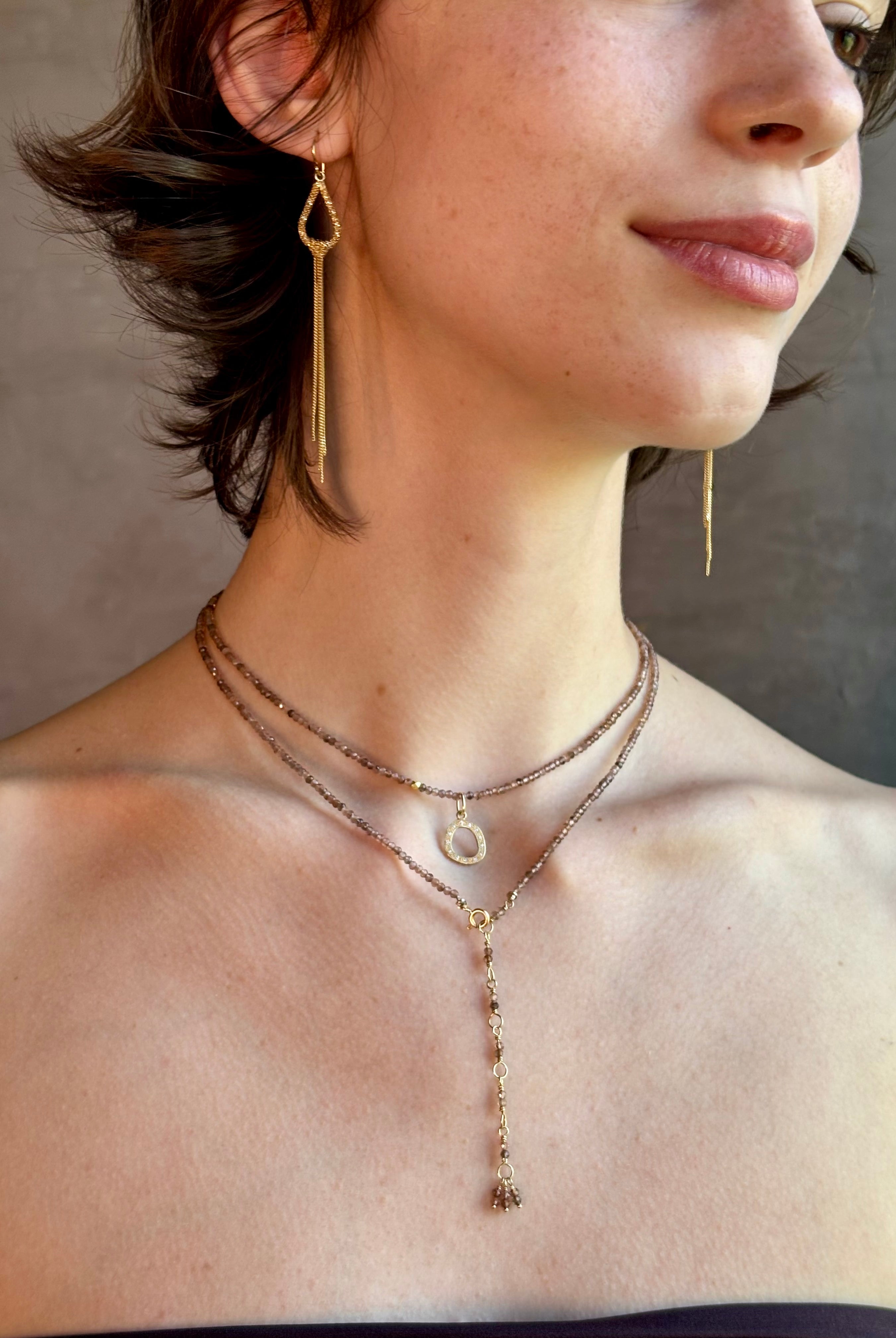 Woman wearing Diamond Charm from Canadian fine jewelry designer Anne Sportun is a perfectly scaled and endlessly versatile jewelry essential. Handcrafted in 18K yellow gold and set with 13 individually quality diamonds in an organic circular form