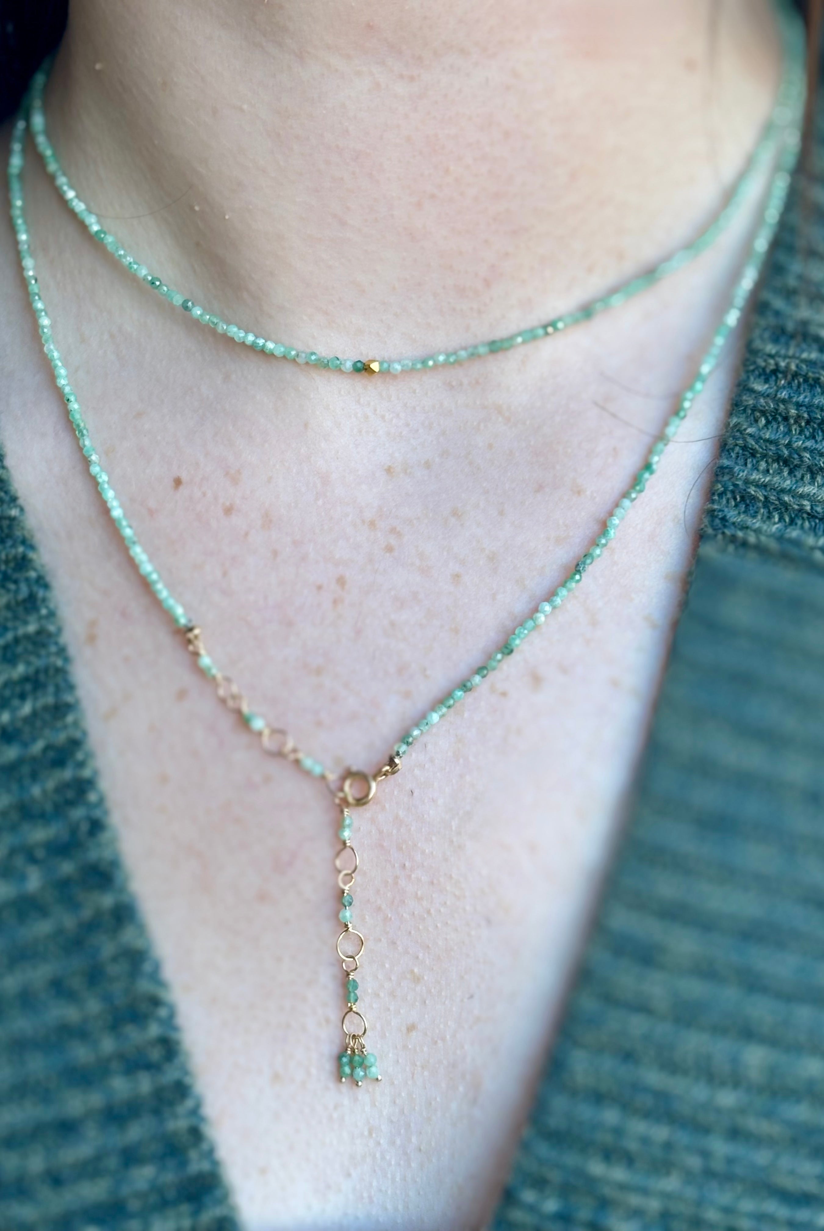 Image of woman wearing Canadian fine jewelry designer ANNE SPORTUN Emerald Wrap Bracelet in 18K Yellow Gold can also be worn as a necklace