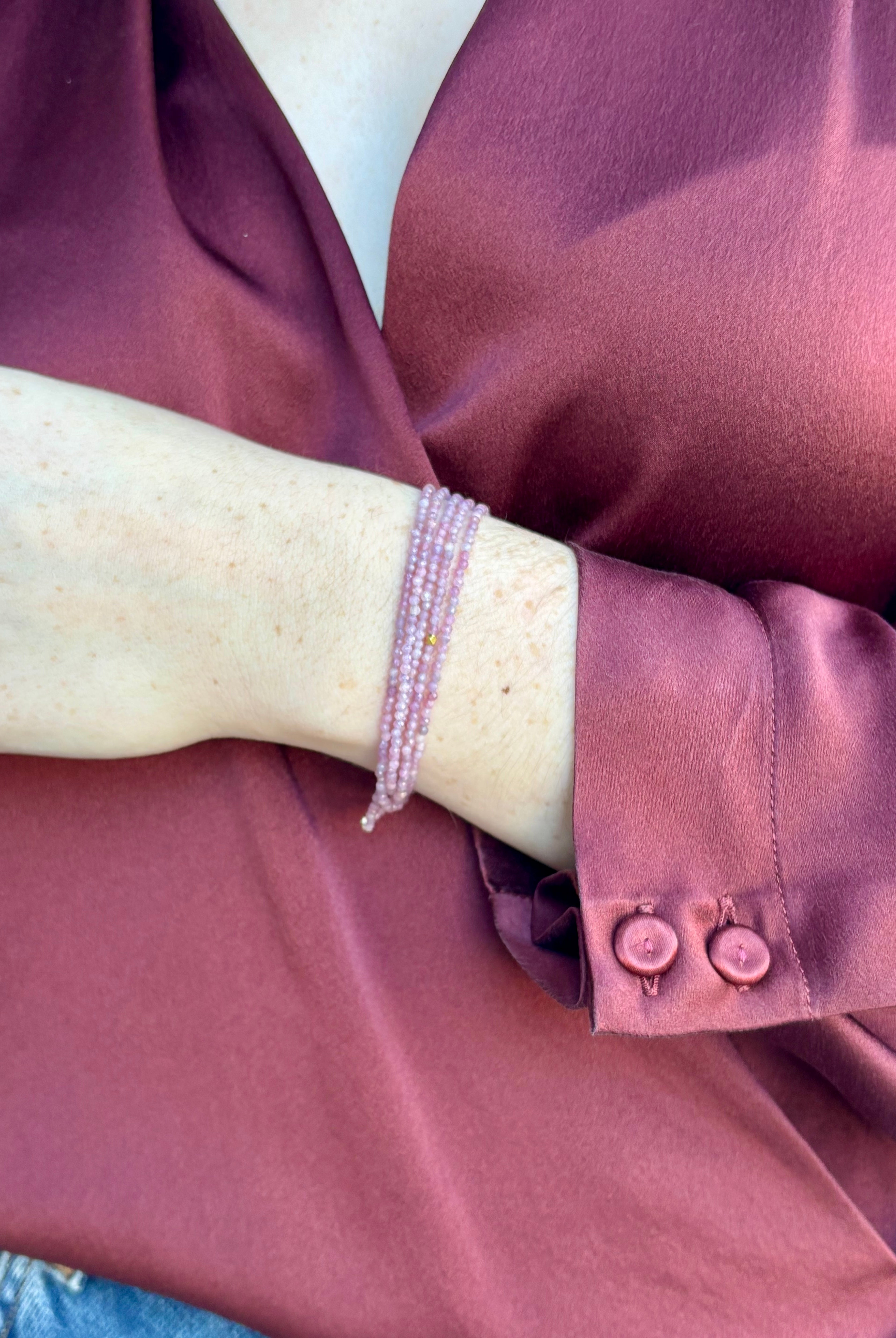 Image of woman wearing Candian jewelry designer ANNE SPORTUN Multi Pink Ruby Wrap Bracelet with 18K Yellow Gold spring clasp