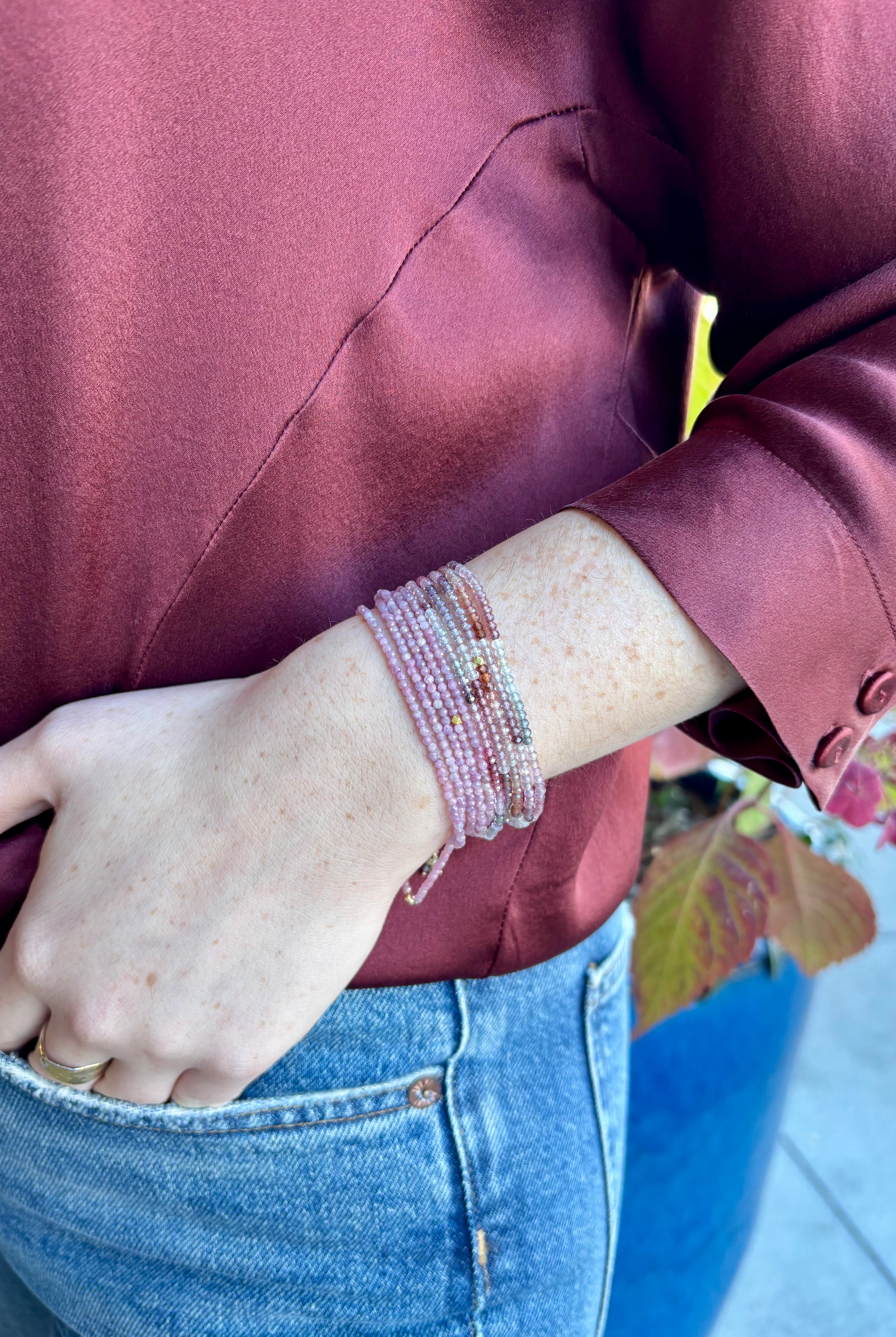 Image of woman wearing Candian jewelry designer ANNE SPORTUN Multi Pink Ruby Wrap Bracelet with 18K Yellow Gold spring clasp