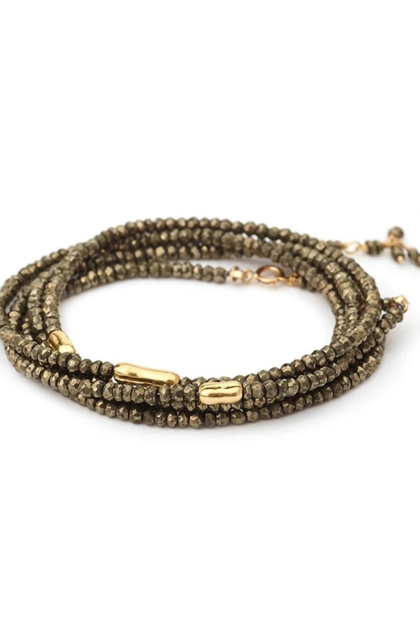 Woman wearing Pyrite River wrap Bracelet from Canadian fine jewelry artist Anne Sportun with pyrite and 18k yellow gold beads that can double as a necklace perfect for travel