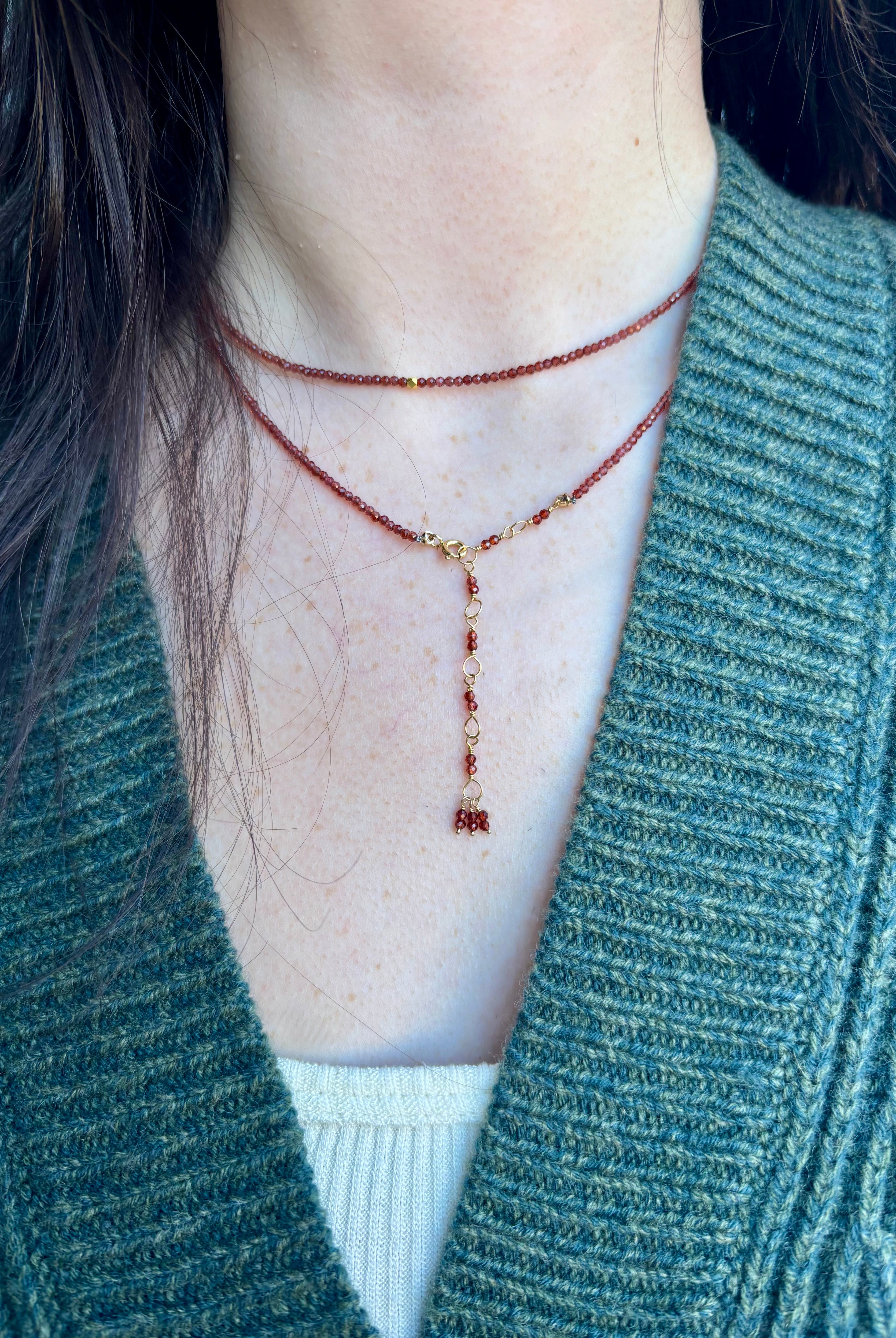 Image of a woman wearing designer Anne Sportun wrap bracelet as a layering necklace for a multi-purpose jewelry perfect for traveling